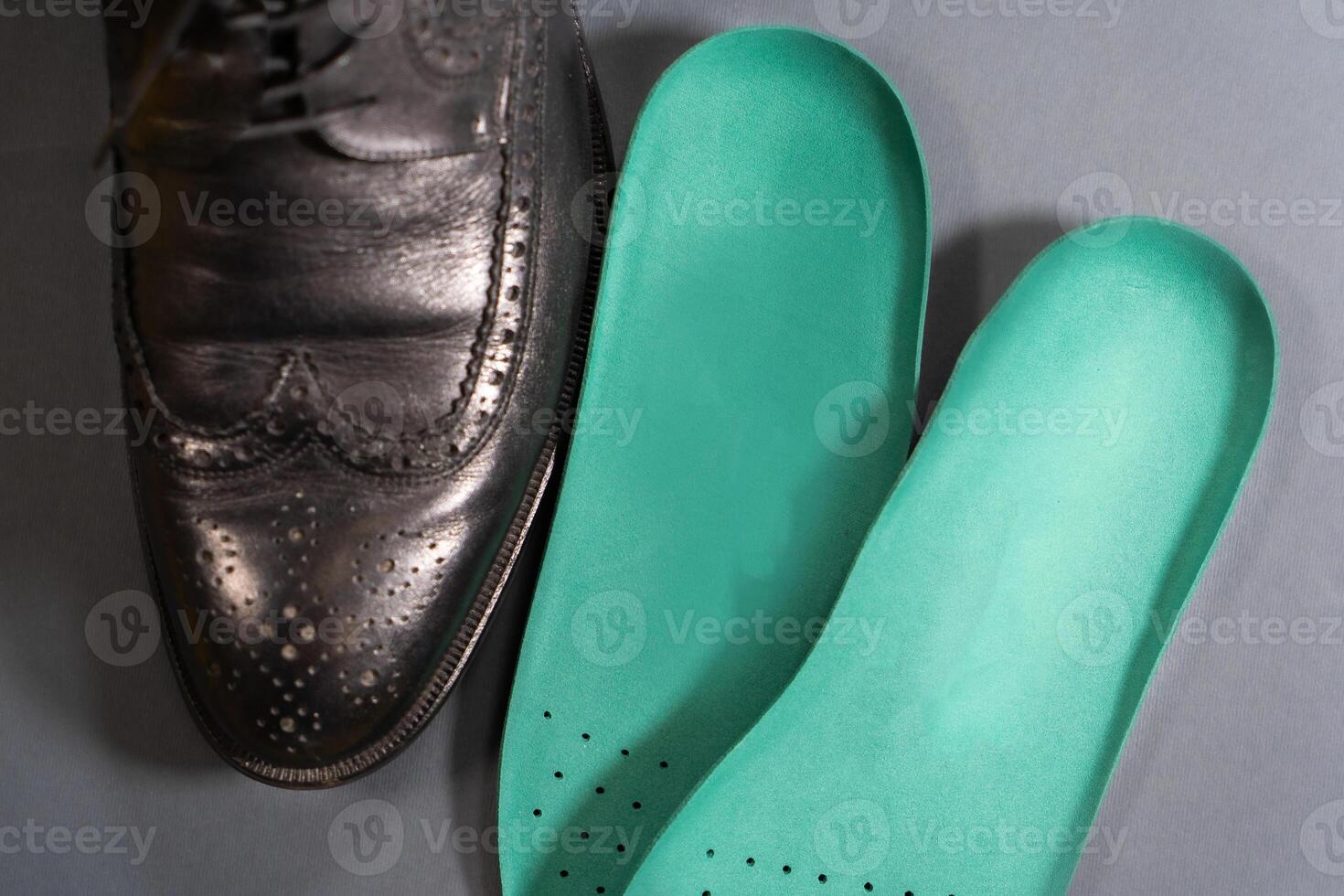 Orthopedic insoles for sports shoes. Treatment and prevention of flatfeet and orthopedic foot diseases. Foot care, feet comfort. Health care, wearing comfortable shoes photo