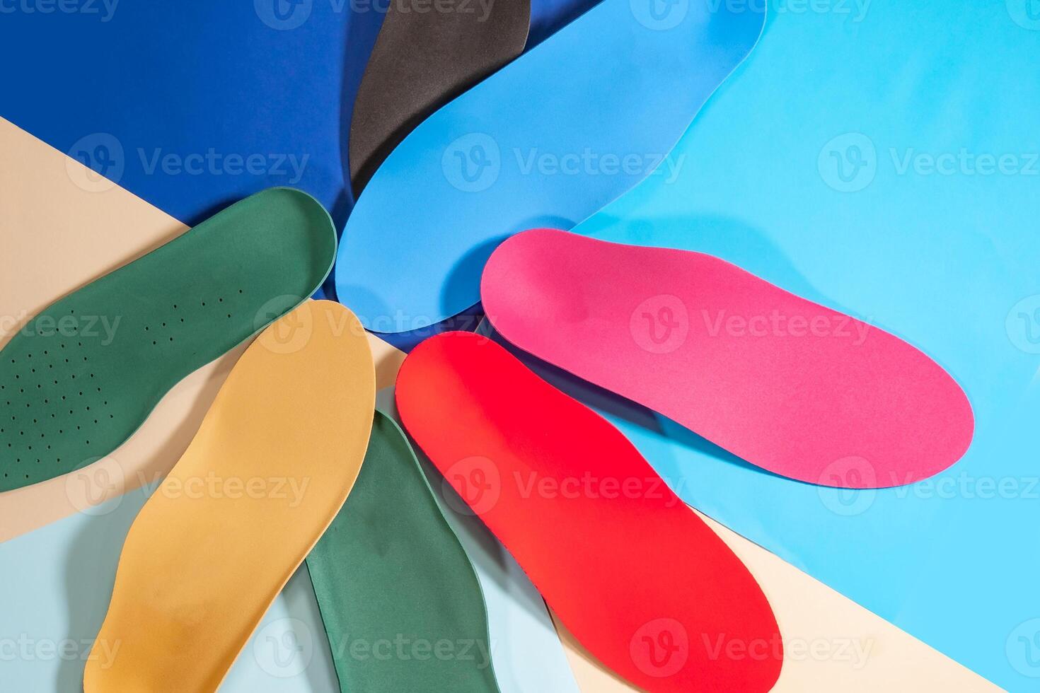 Orthopedic insoles for shoes on a colour background. Foot care photo