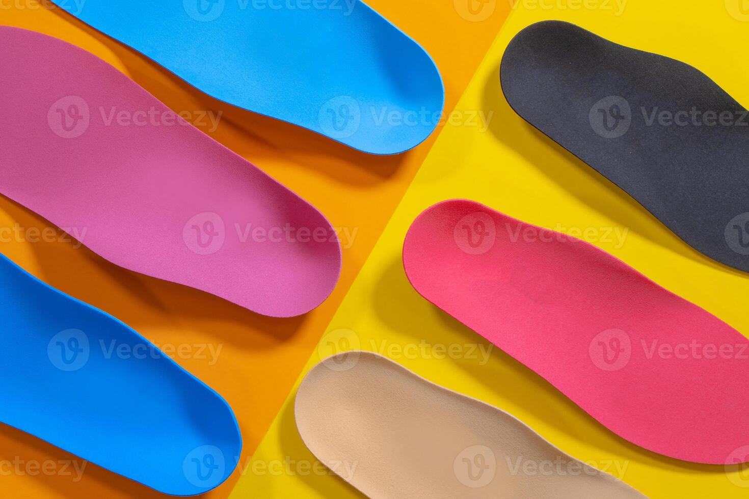 Orthopedic insoles for shoes on a colour background. Foot care photo
