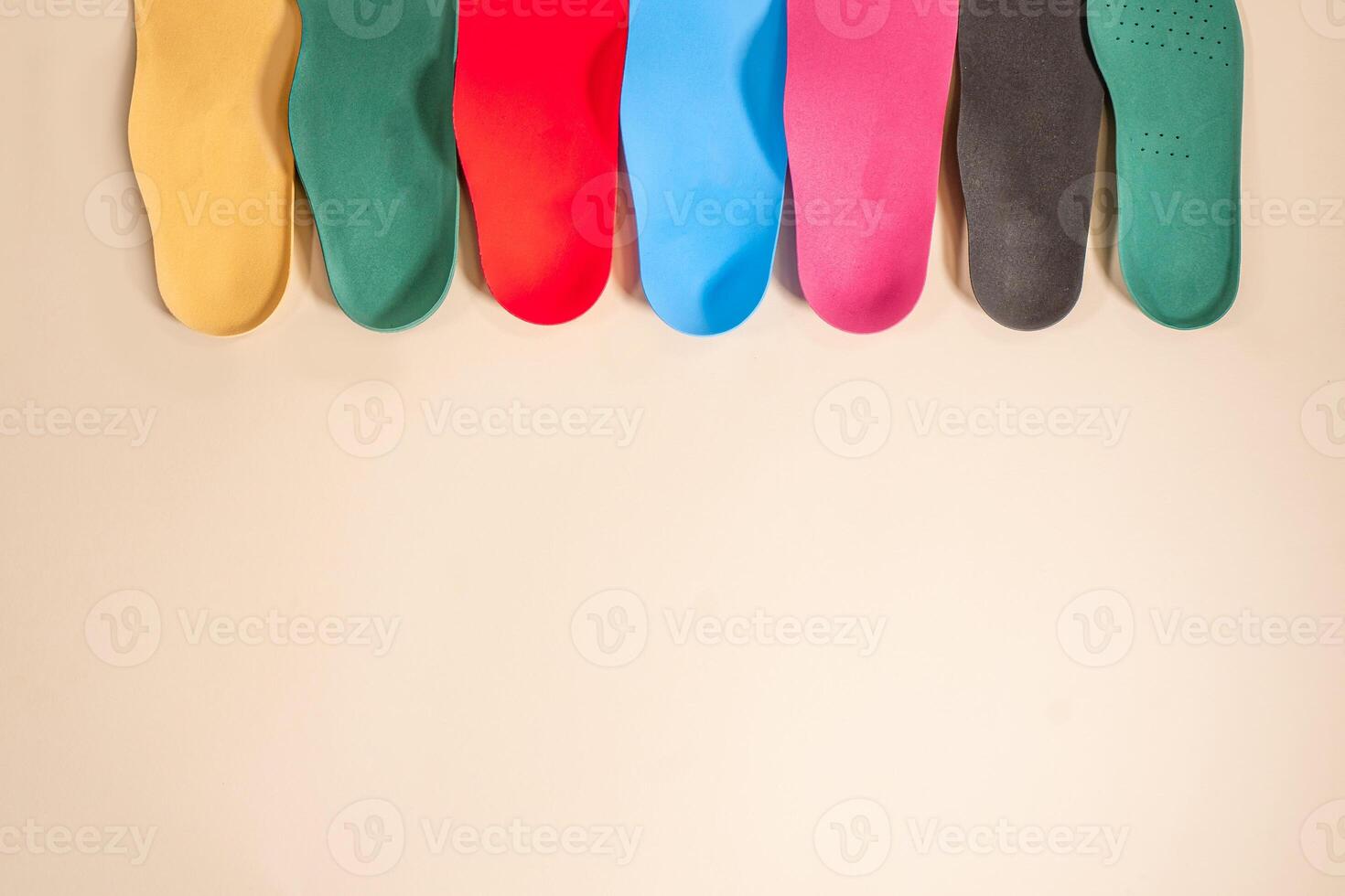 Orthopedic insoles for shoes on a colour background. Foot care photo