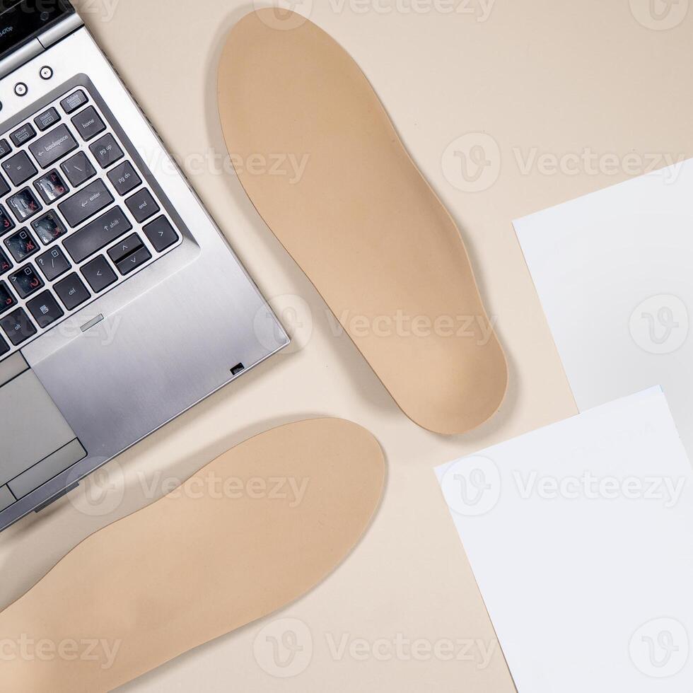 Orthopedic insoles for shoes on a colour background. Foot care photo
