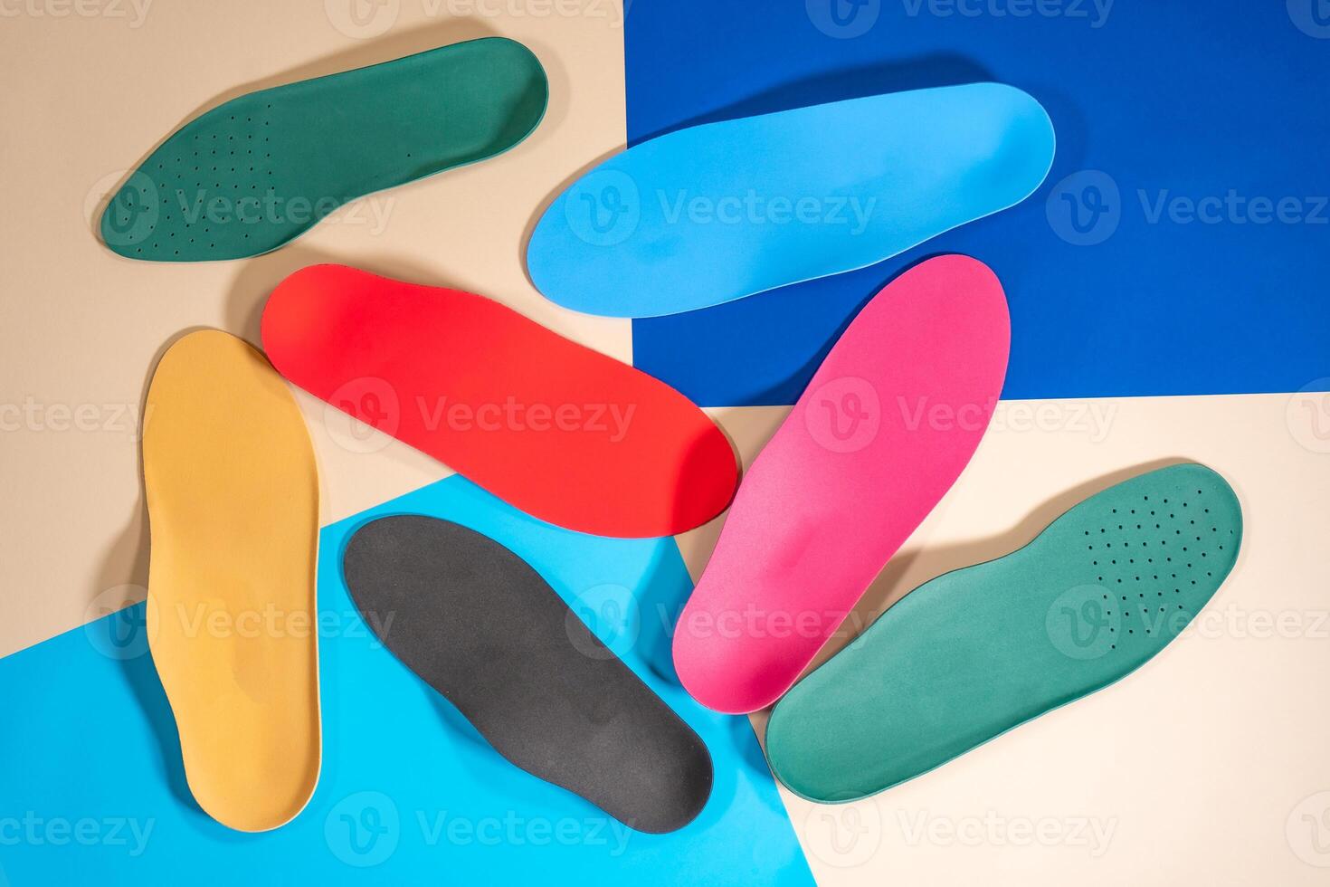 Orthopedic insoles for shoes on a colour background. Foot care photo