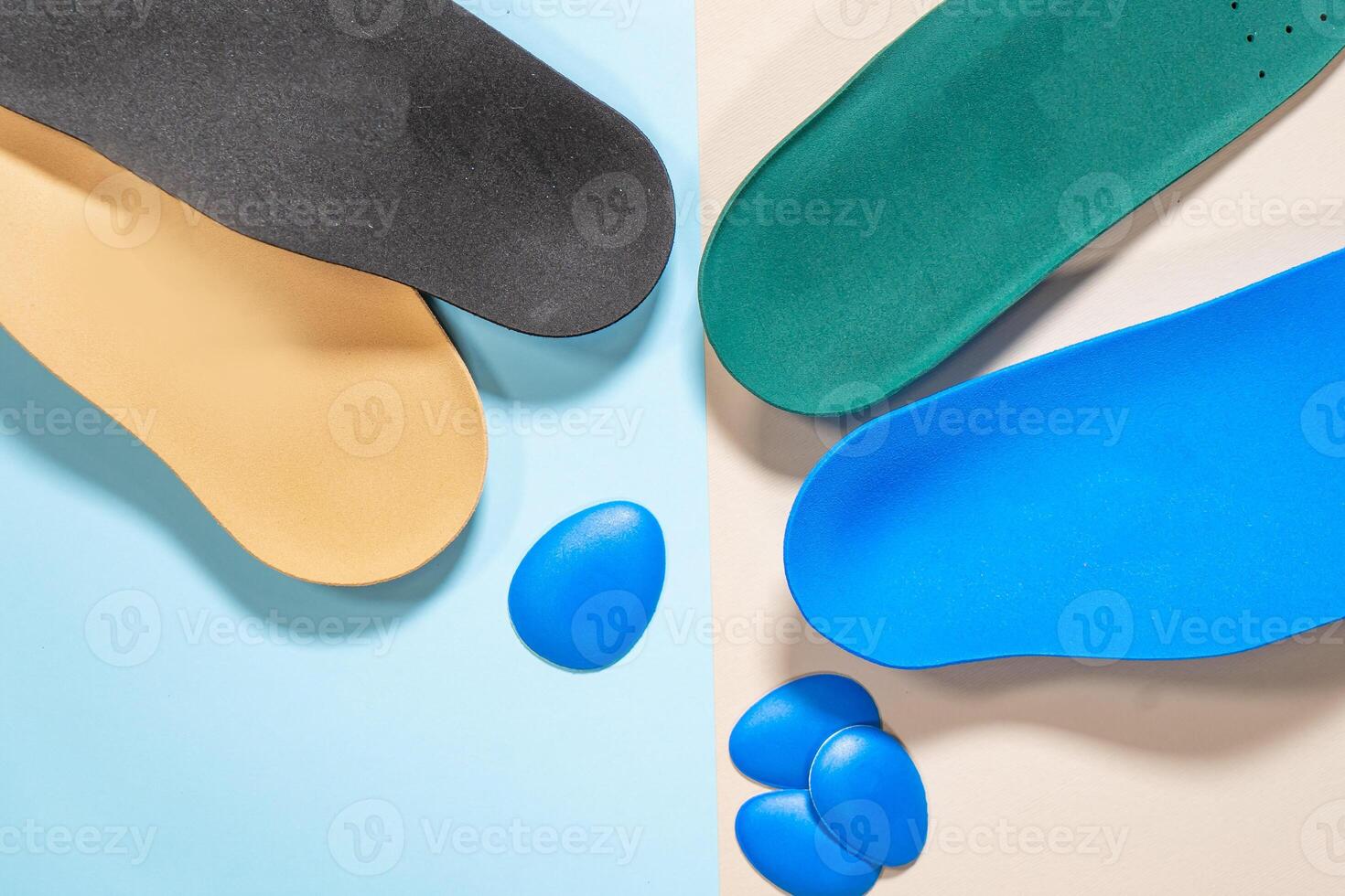 Orthopedic insoles for shoes on a colour background. Foot care photo