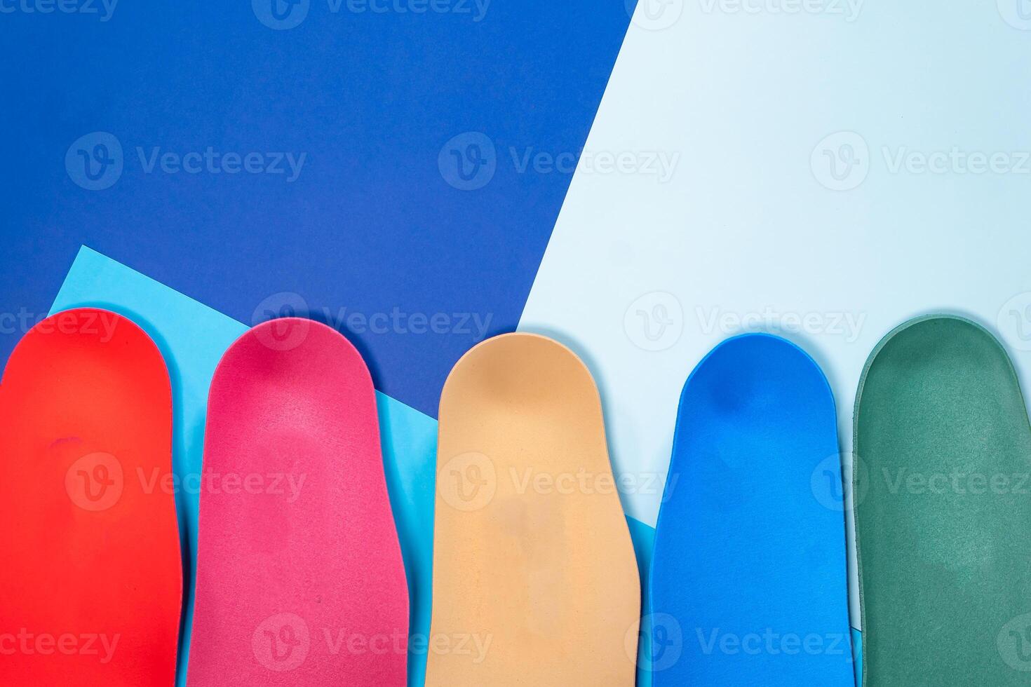 Orthopedic insoles for shoes on a colour background. Foot care photo