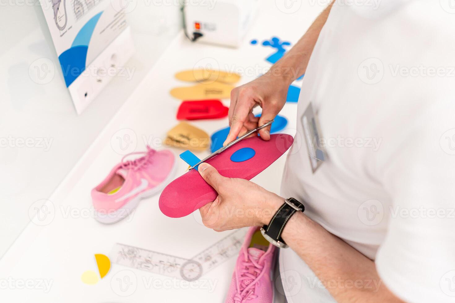 Orthopedic insole. The orthopedist works with the patient. Orthopedic clinic. Choice of insoles in an orthopedic clinic. The orthopedist offers the insole to the patient Foot care photo