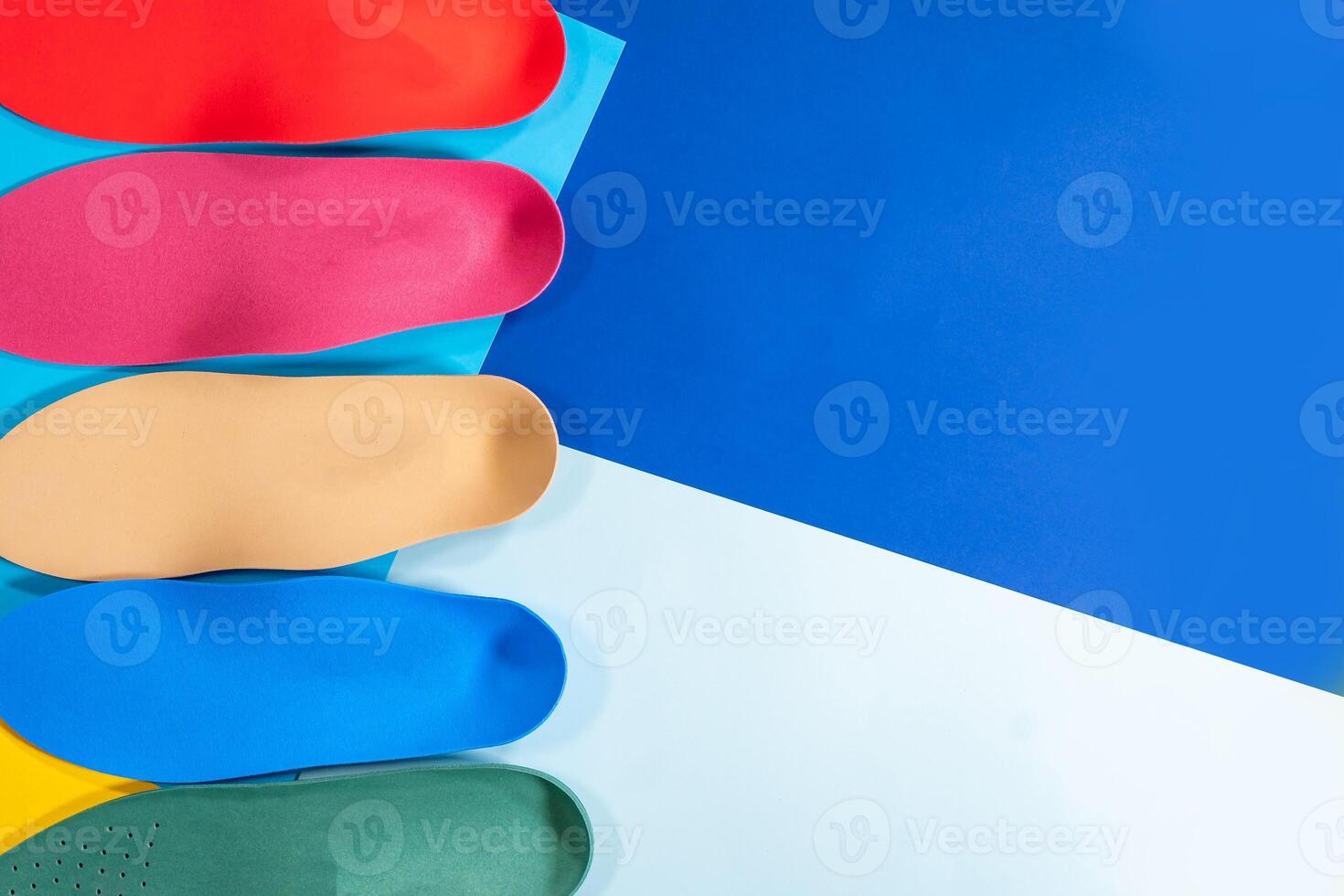 Orthopedic insoles for shoes on a colour background. Foot care photo