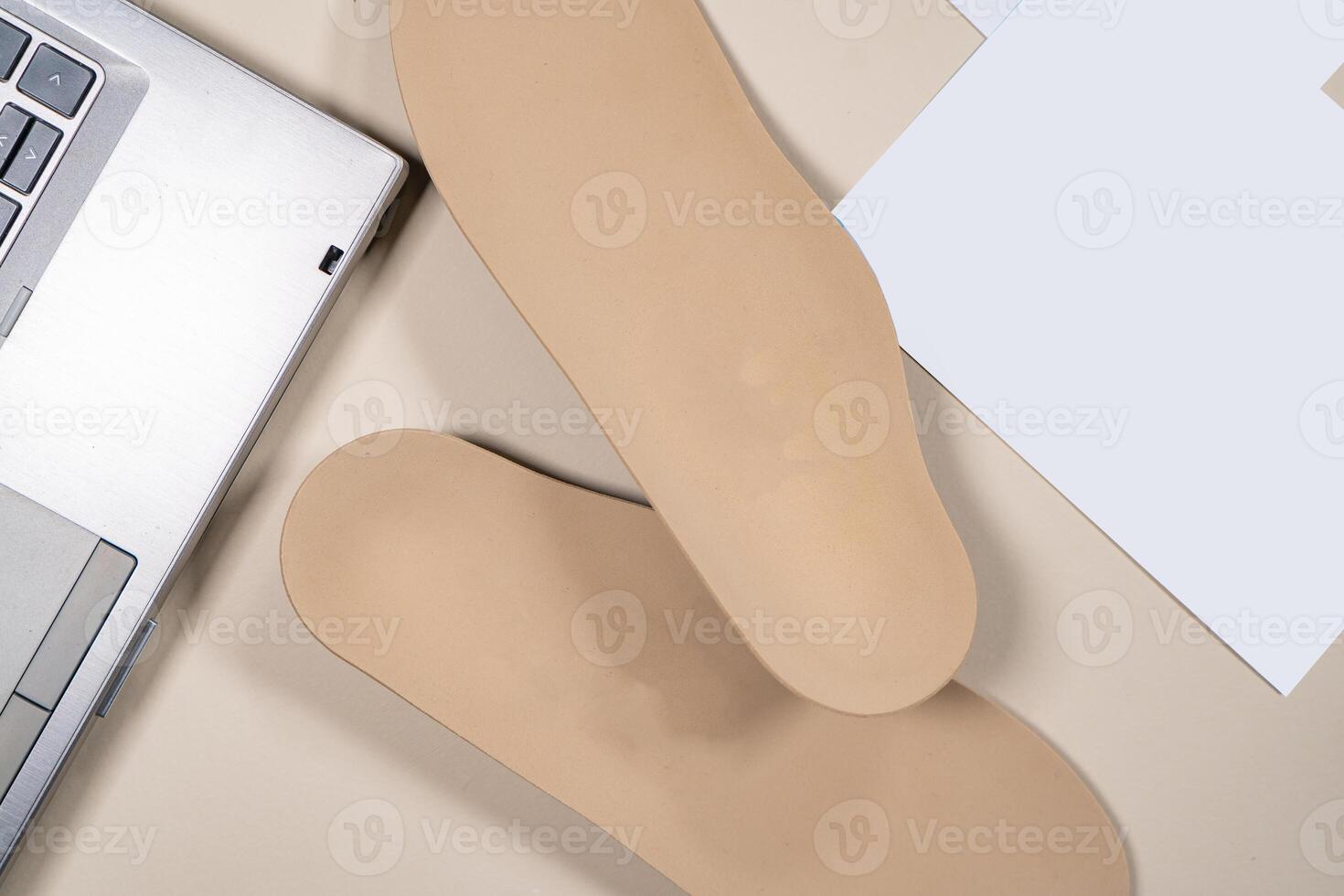 Orthopedic insoles for shoes on a colour background. Foot care photo