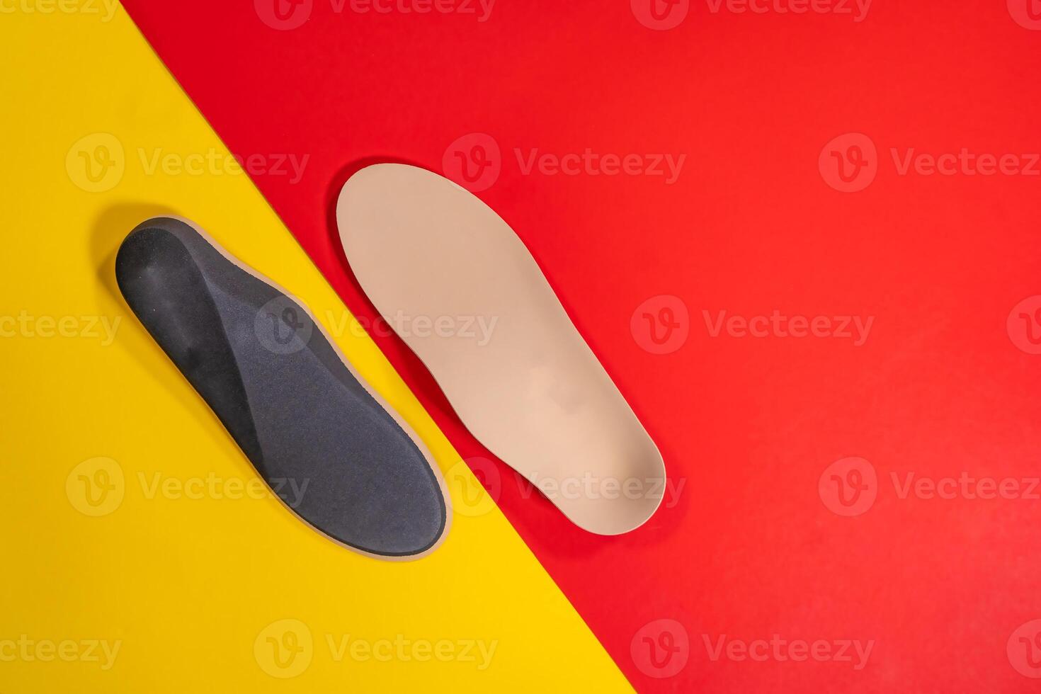 Foot support and healthy feet concept with orthopedic shoe insoles isolated on color background photo