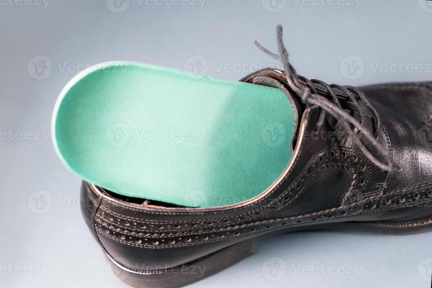 Orthopedic insoles for sports shoes. Treatment and prevention of flatfeet and orthopedic foot diseases. Foot care, feet comfort. Health care, wearing comfortable shoes photo