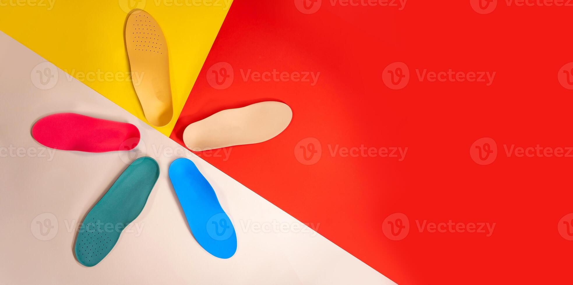Orthopedic insoles for shoes on a colour background. Foot care photo