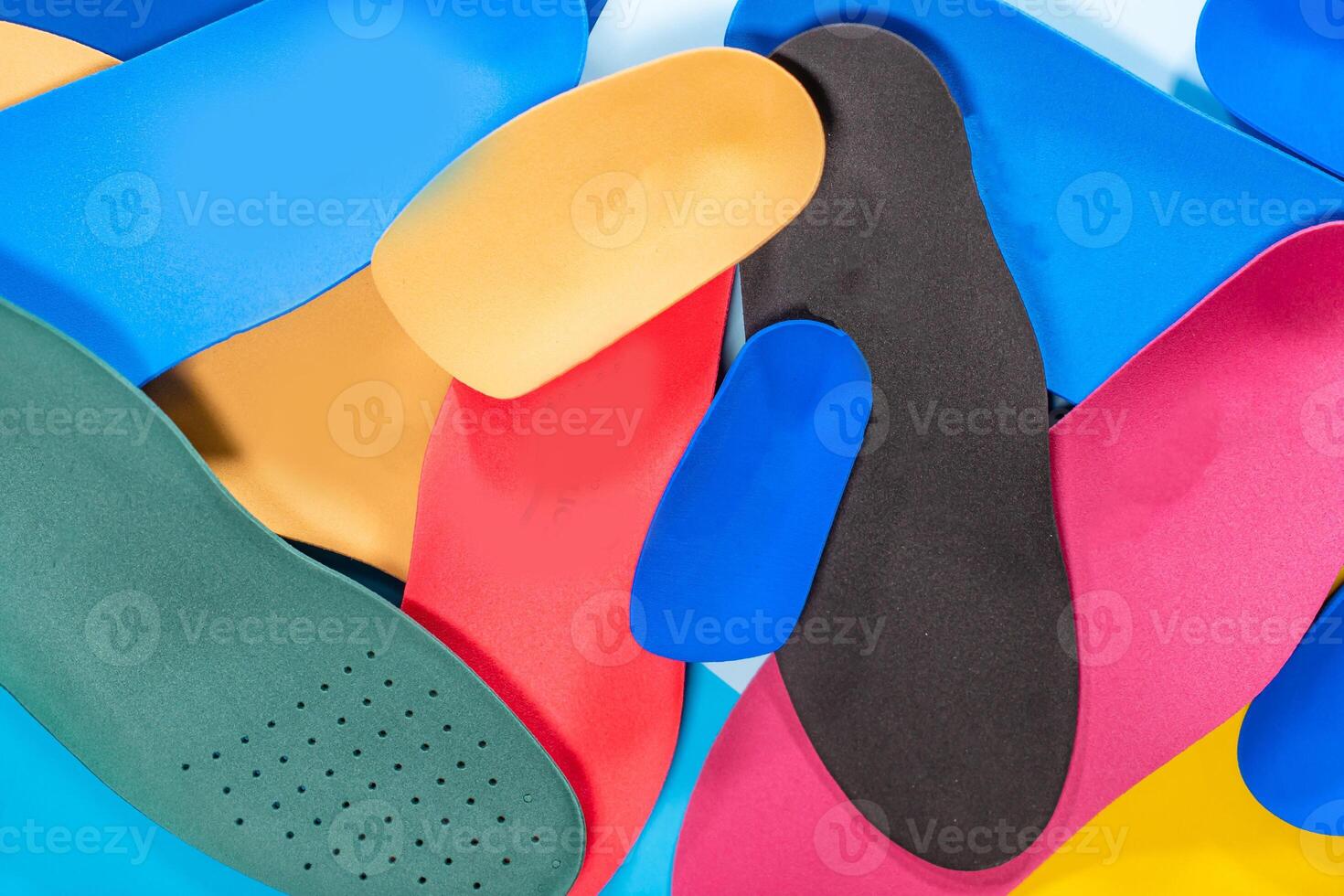 Foot support and healthy feet concept with orthopedic shoe insoles isolated on color background photo