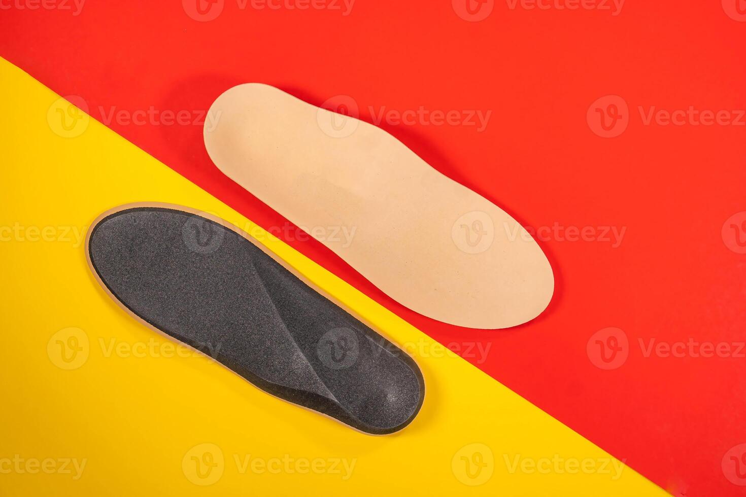 Foot support and healthy feet concept with orthopedic shoe insoles isolated on color background photo