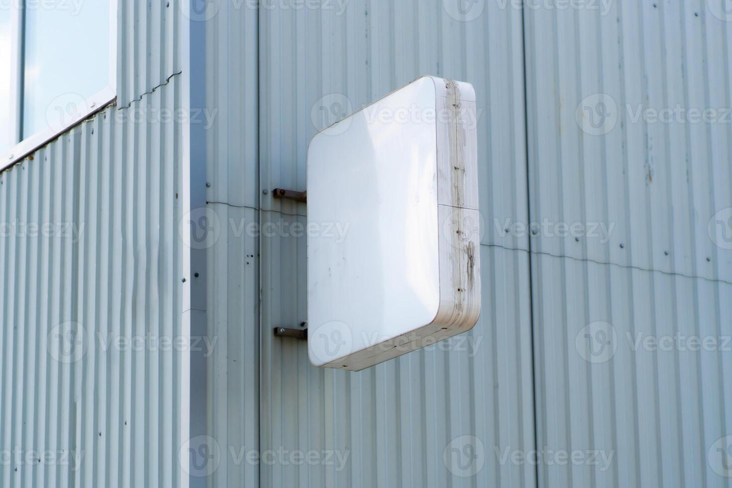 Rectangular light box with company name on concrete building wall. Concept of advertising and marketing. mock up photo