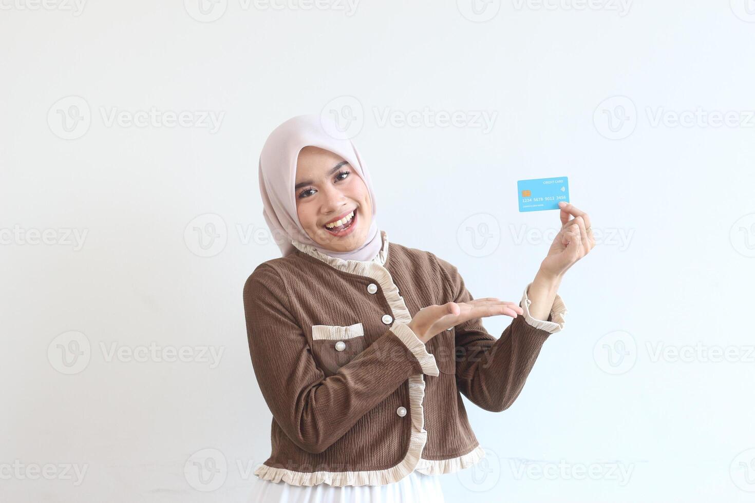Smiling Woman in Hijab Showing Credit Card Online Shopping Happy Customer E-commerce photo