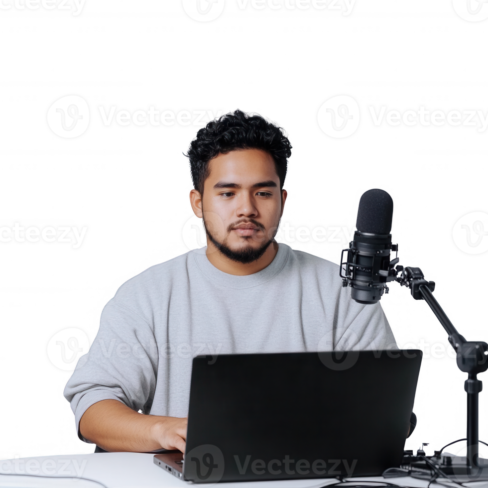 Young man engaging in online content creation with a laptop and microphone. png