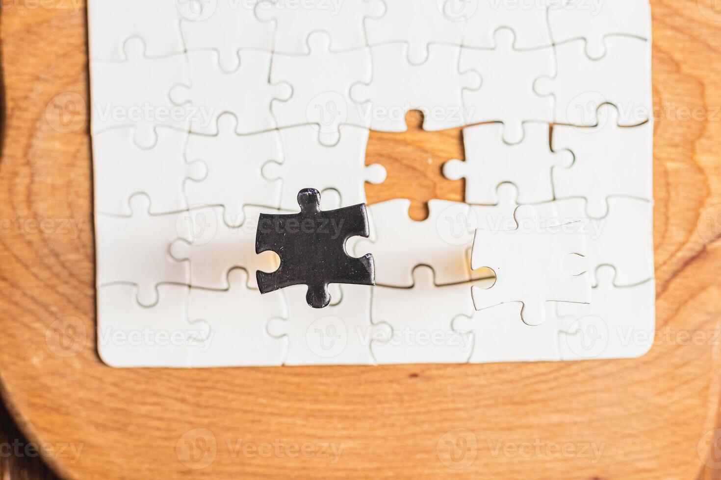 Opposite day concept using white and black puzzle pieces on a white background photo
