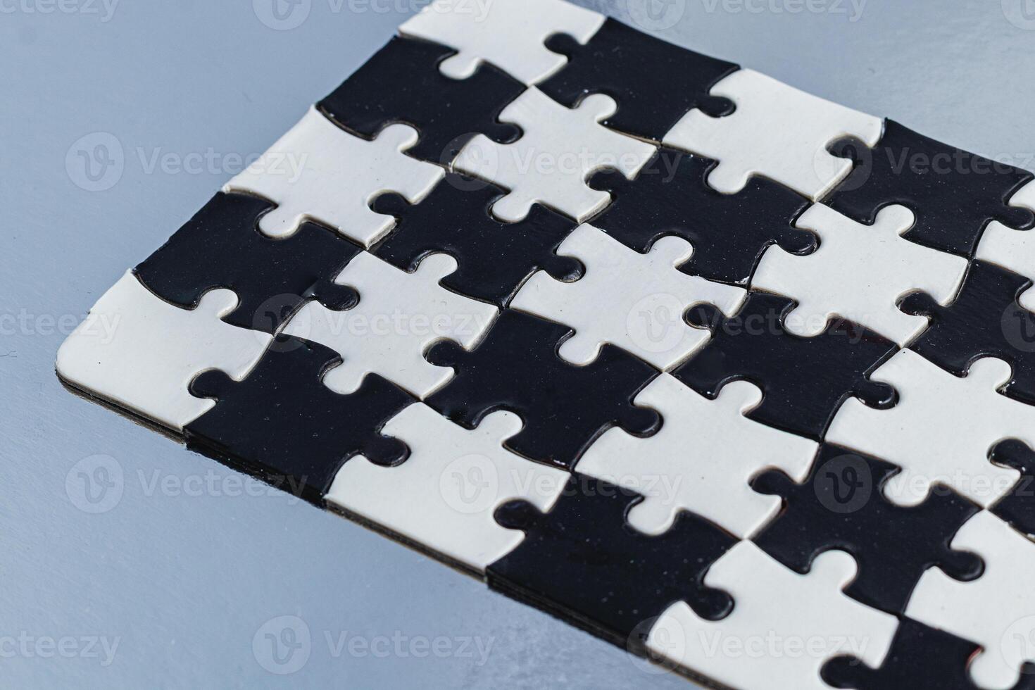 Black and white puzzle, teamwork challenge concept photo