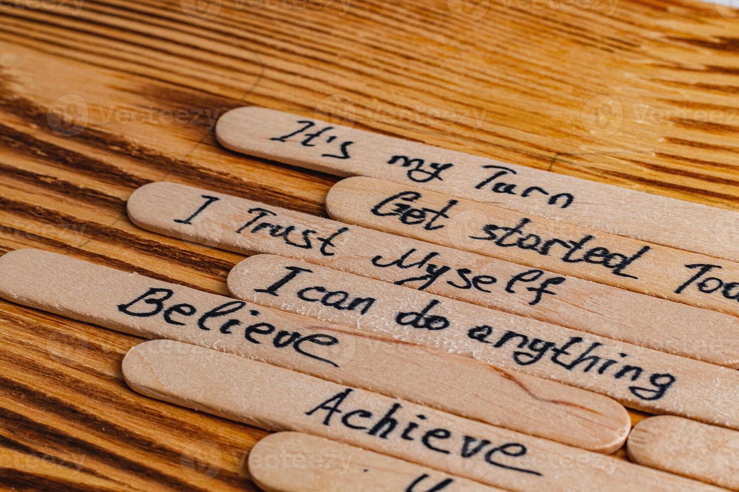 Positive thoughts for increasing selfesteem on wooden posts on wooden background photo