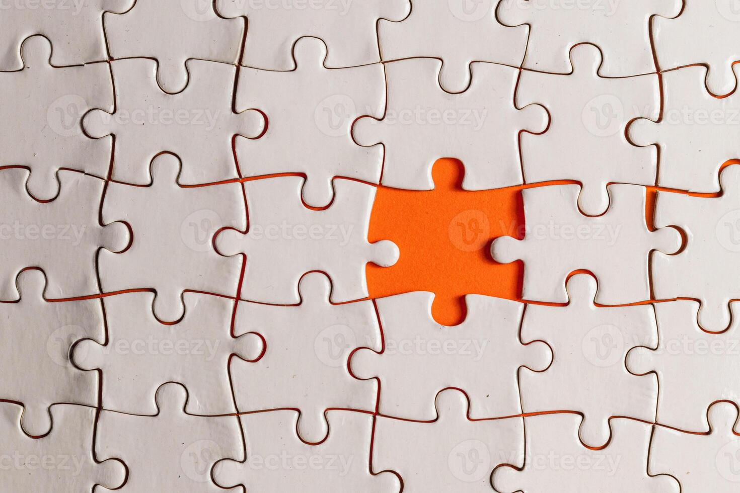 Conceptual photo of a puzzle, missing piece, on an orange background