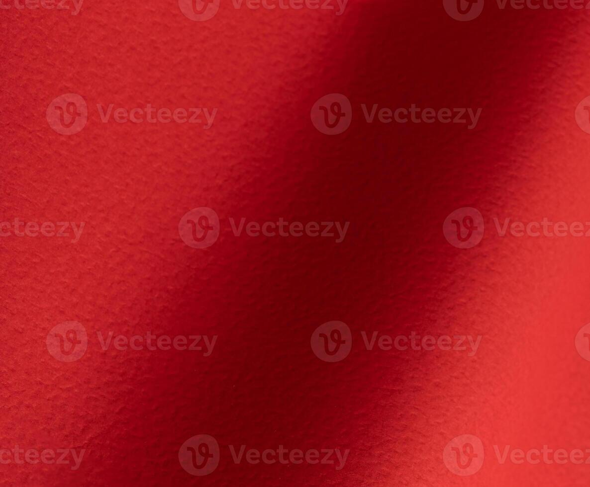 Rich scarlet paper texture with a grainy, perforated surface and soft gradients of crimson and ruby photo