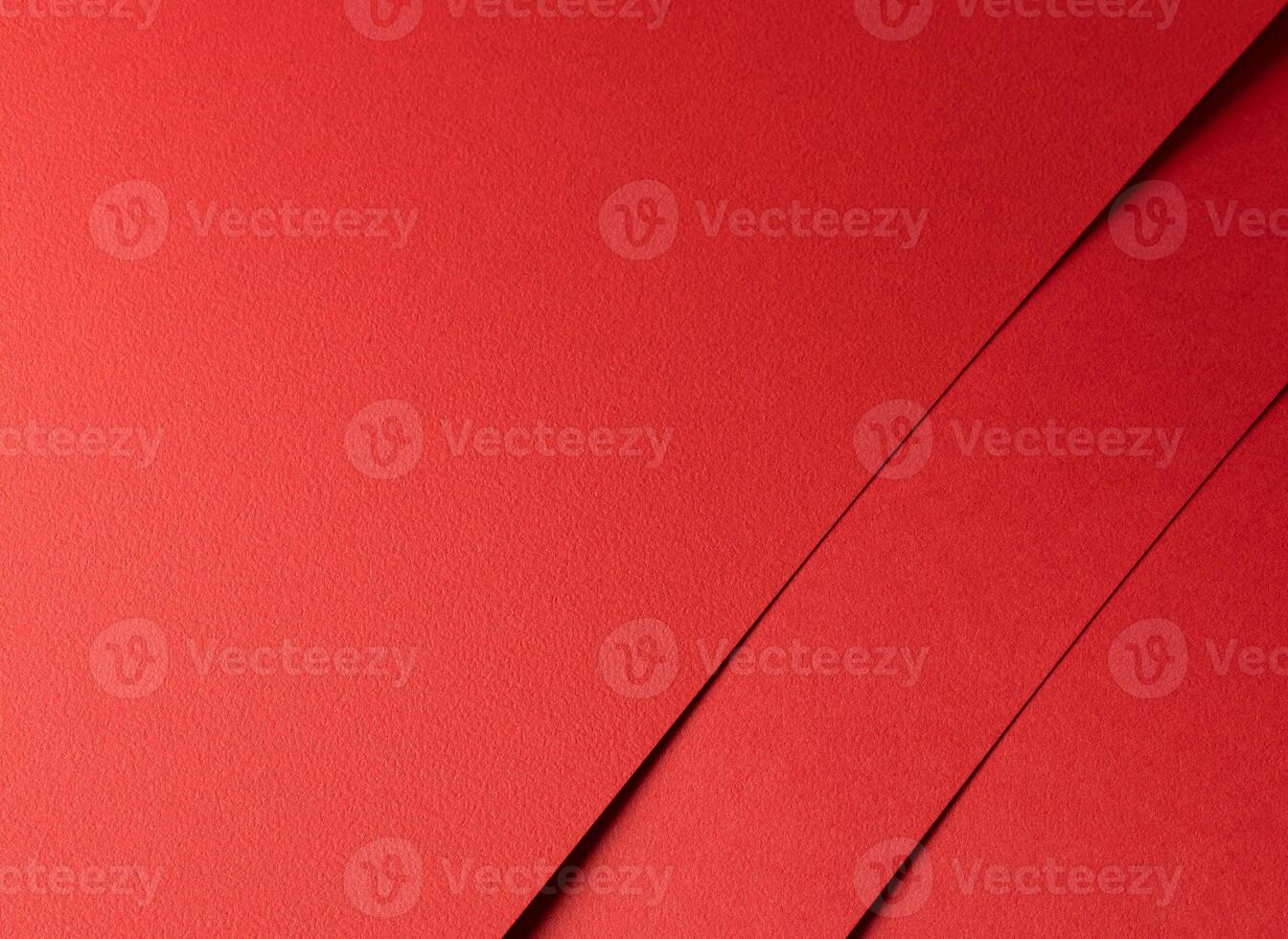 Scarlet red paper texture with a smooth, vibrant surface and bold overlapping lines. The rich, warm photo
