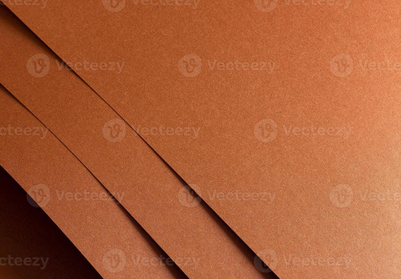 Copper and rust paper texture with a grainy, metallic finish in warm tones of orange, brown, and photo