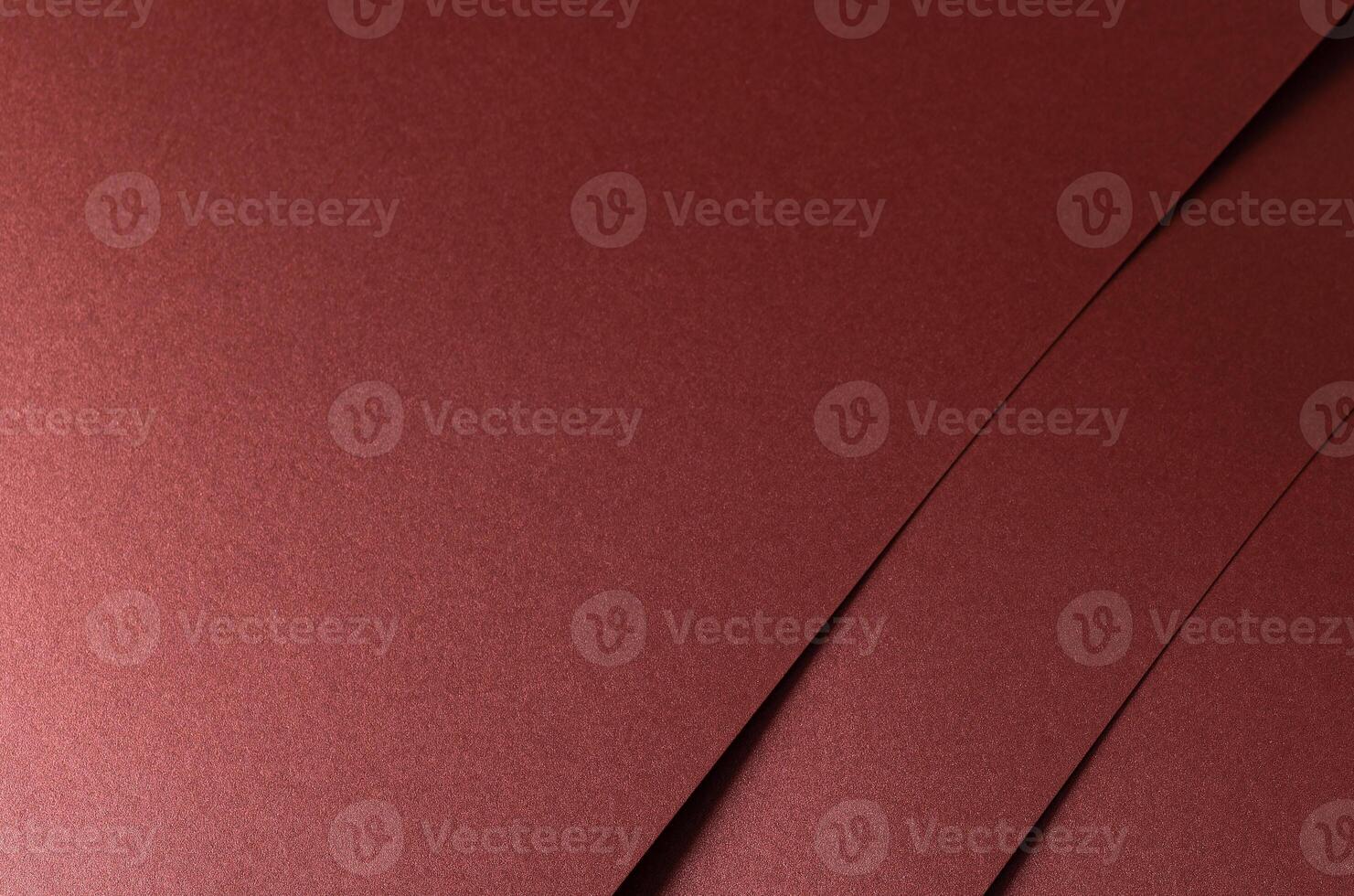 Burgundy red metallic satin paper texture with a pearlescent shimmer. The warm red-brown tones and photo