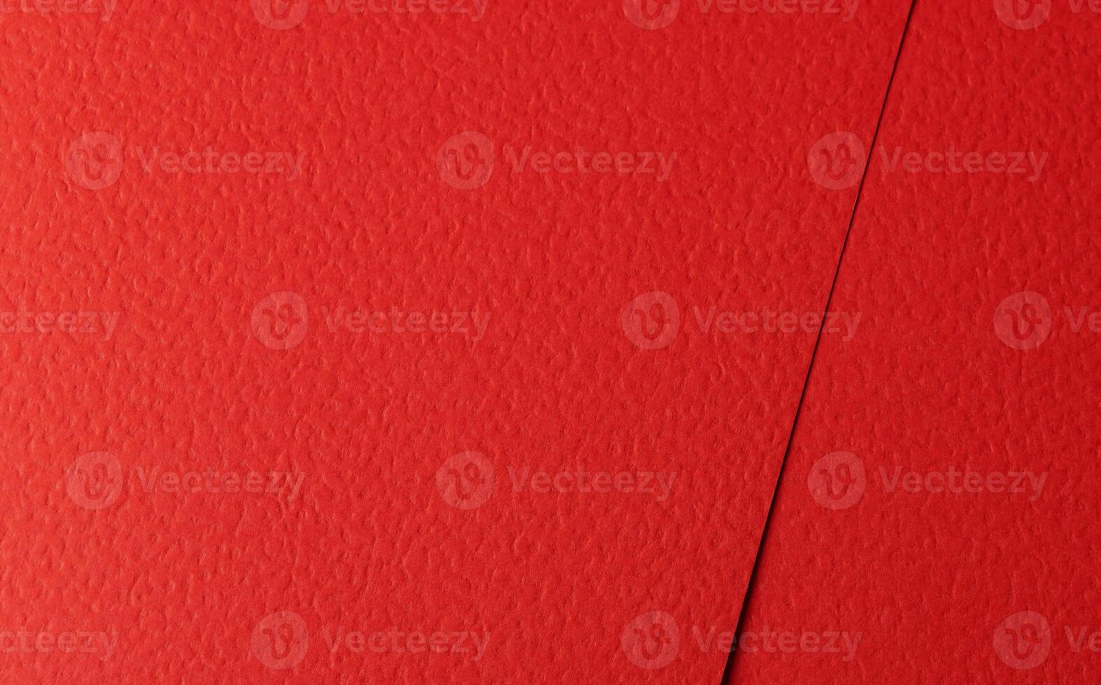 Bright scarlet paper texture with a grainy, perforated surface and deep crimson tones. The solid, photo