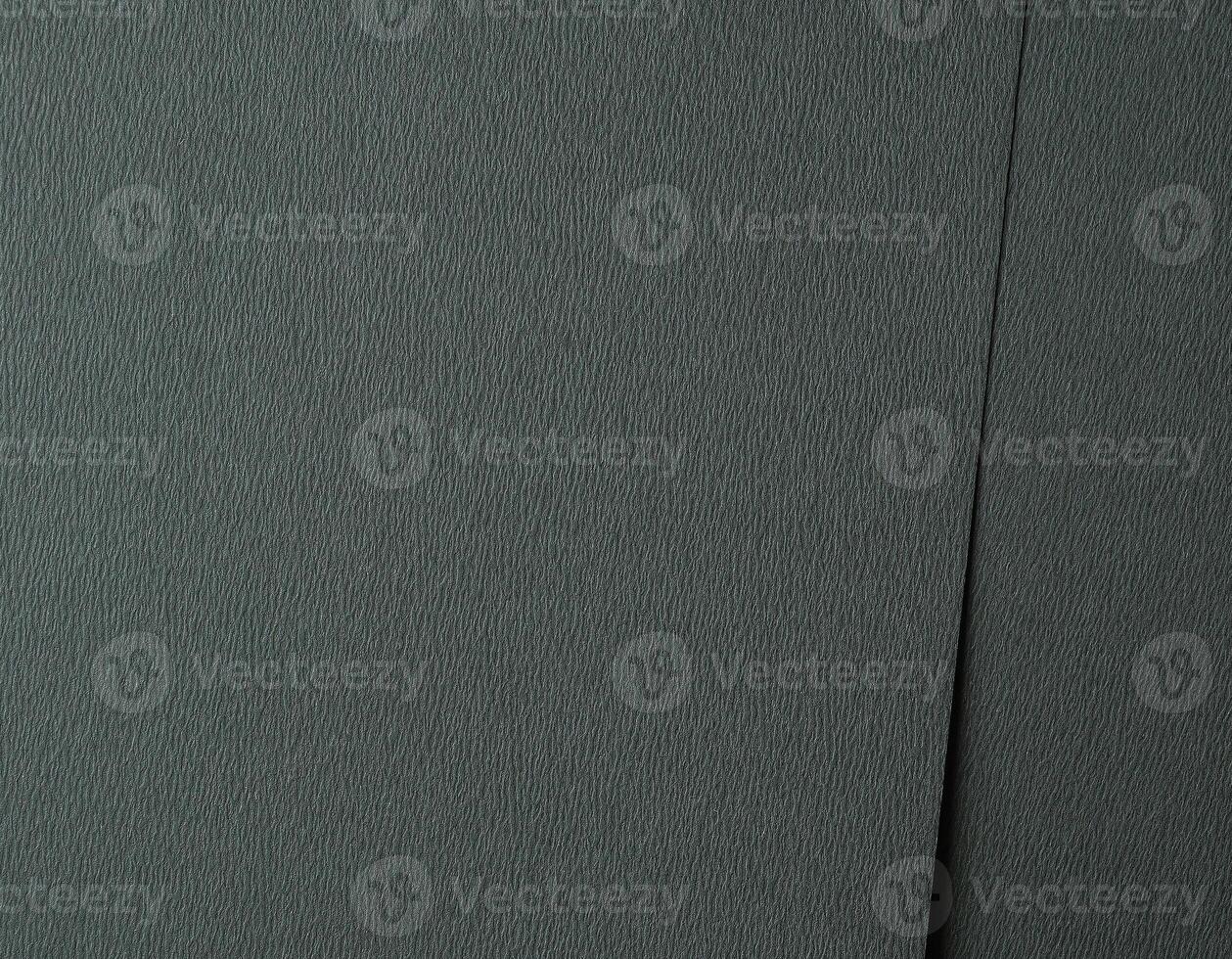 Dark green paper texture with an embossed, wavy leather like pattern in deep teal and forest green photo