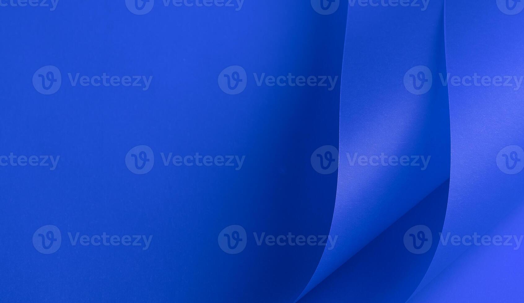 Elegant royal blue paper background with a rich matte texture and subtle wavy folds. Vibrant deep photo