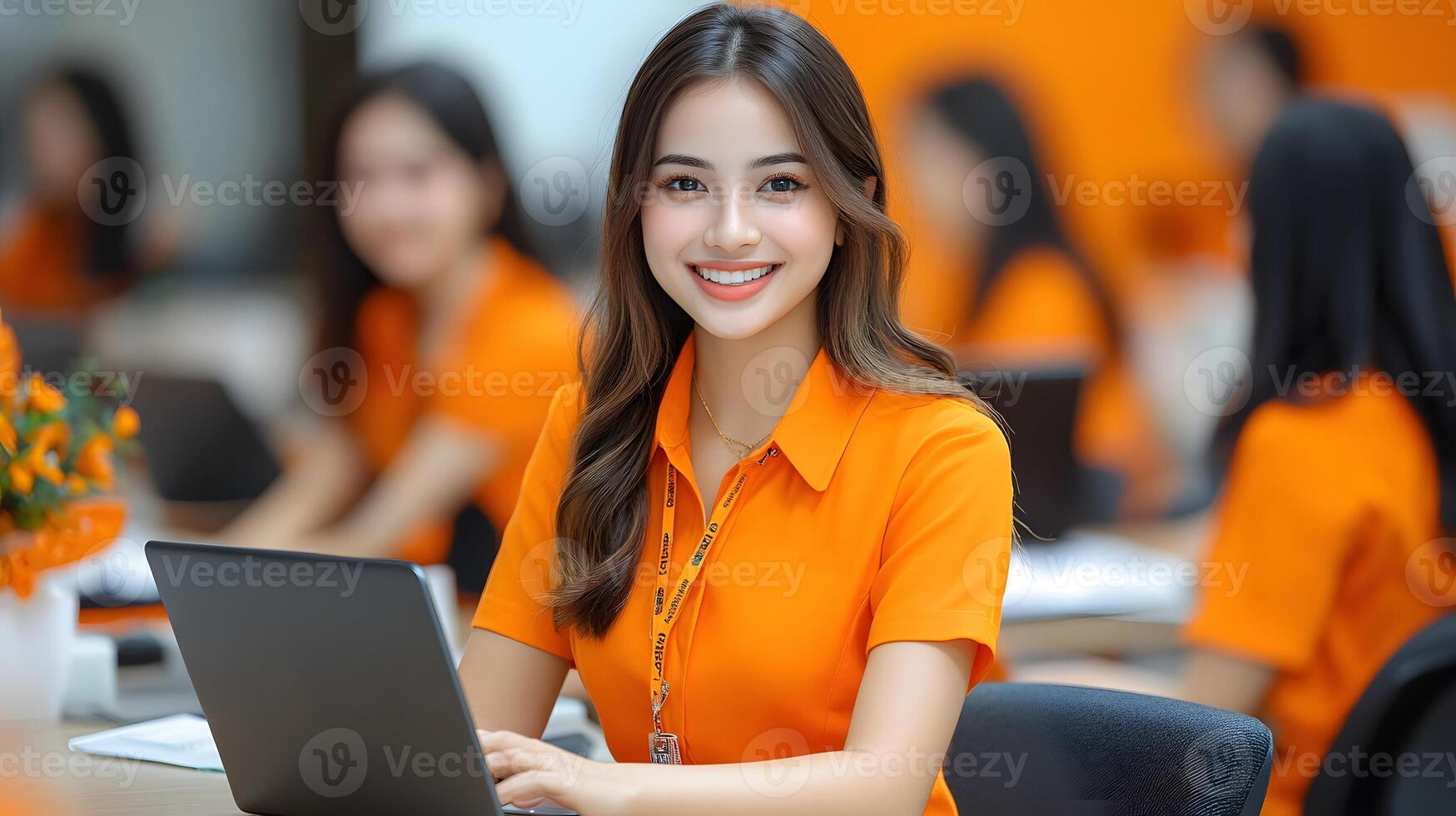 Professional meeting with Asian female leader using laptop, colleagues seated around the table photo