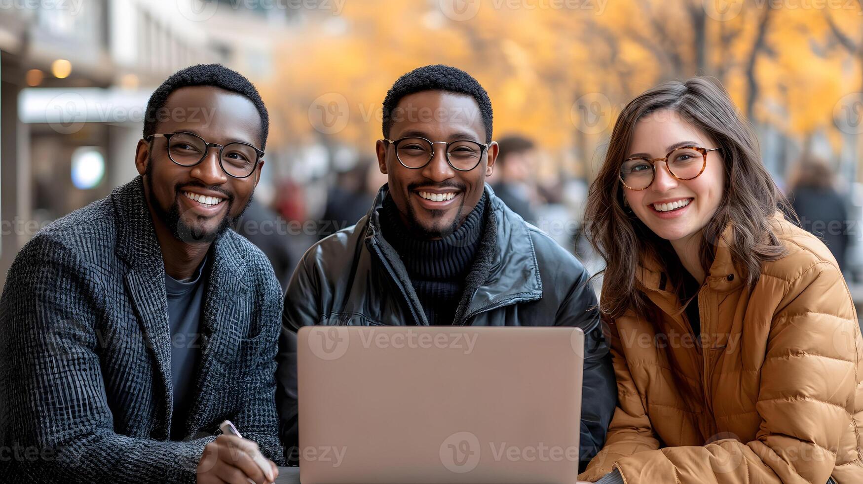 Entrepreneurial team collaborating on a project with a laptop, in a high-rise office with city views photo