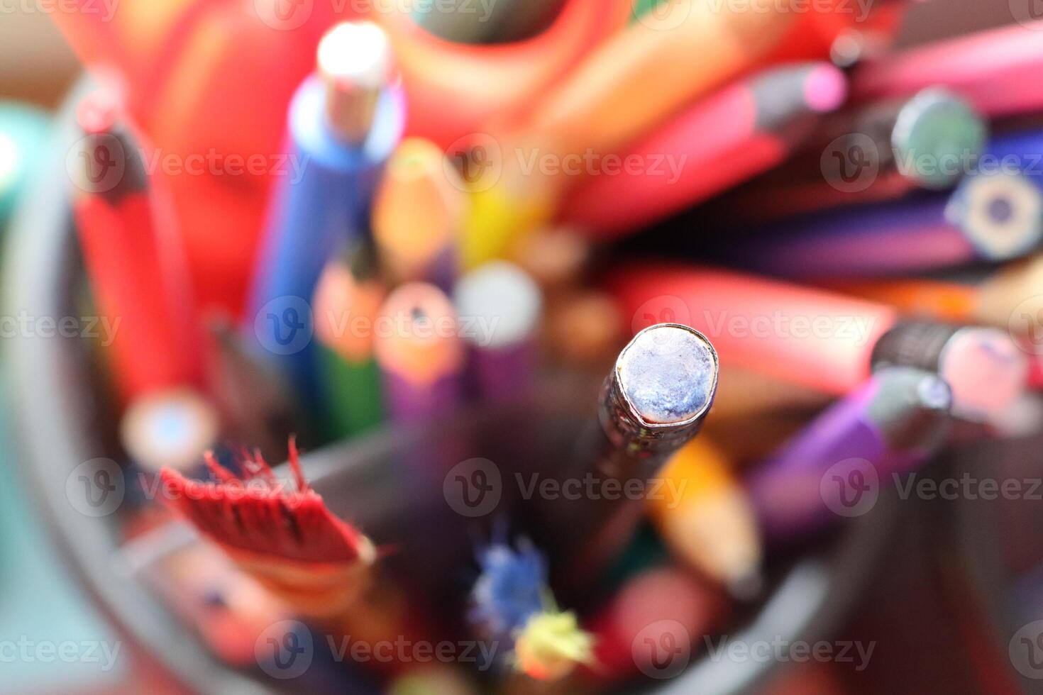 A Bright, Colorful and Dynamic Collection of Various Art Supplies Displayed Within a Jar photo