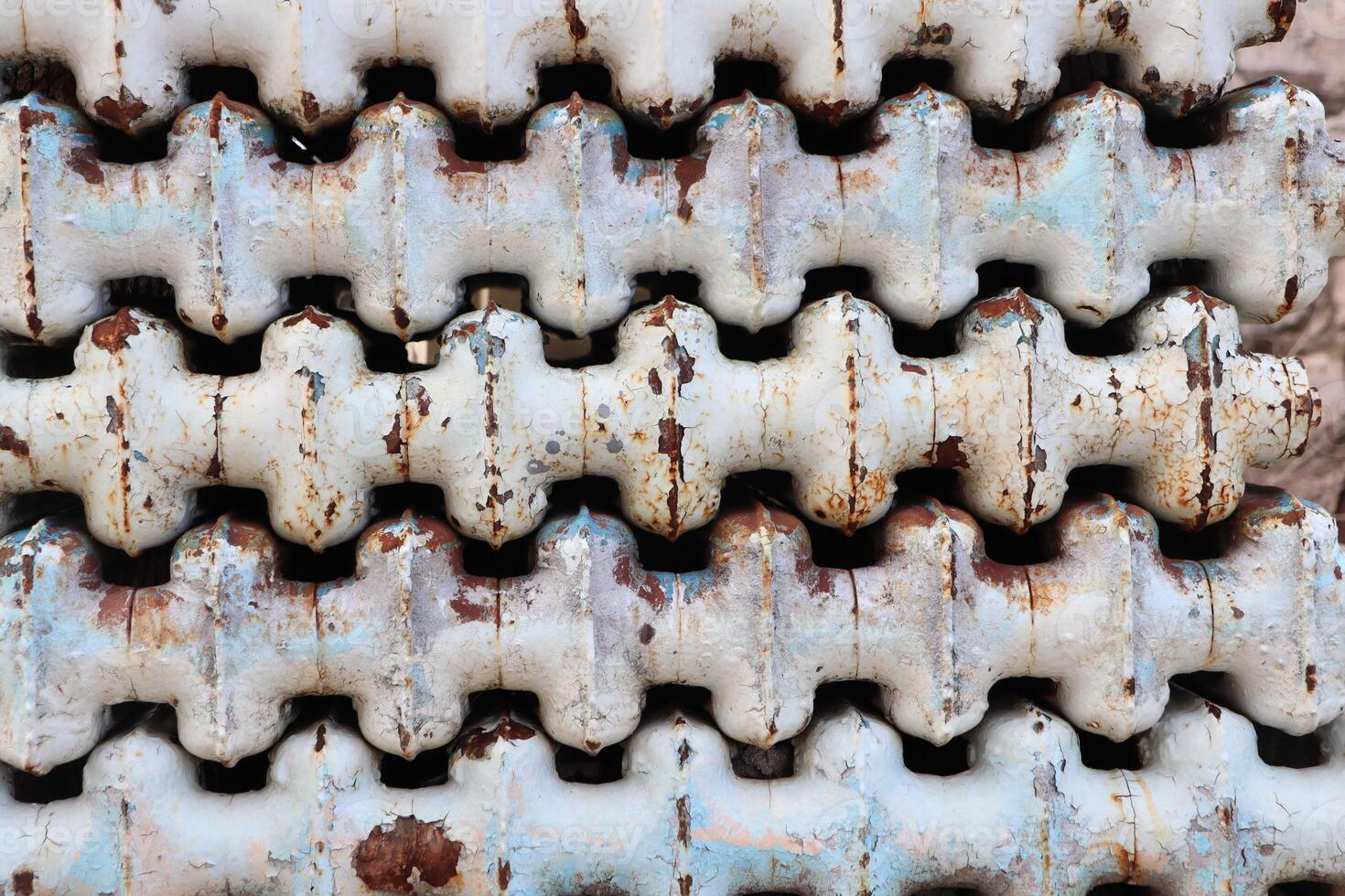 A CloseUp of Textured Metal Radiators Featuring Various Rust and Patina Details photo