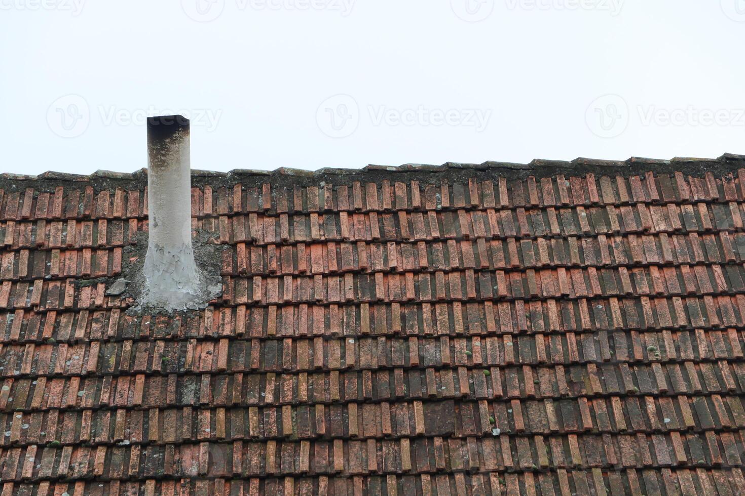 A charming rooftop showcasing a traditional chimney in a beautiful rustic style photo