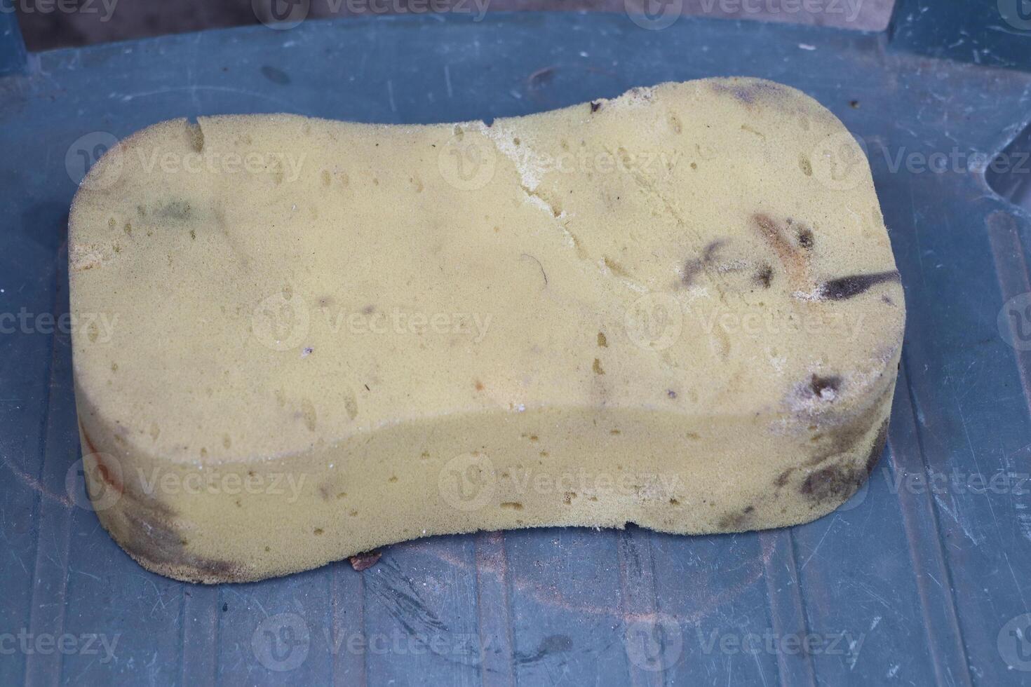 A Natural Sponge Sitting on a Blue Surface, Ideal for Cleaning and Daily Bathing Needs photo