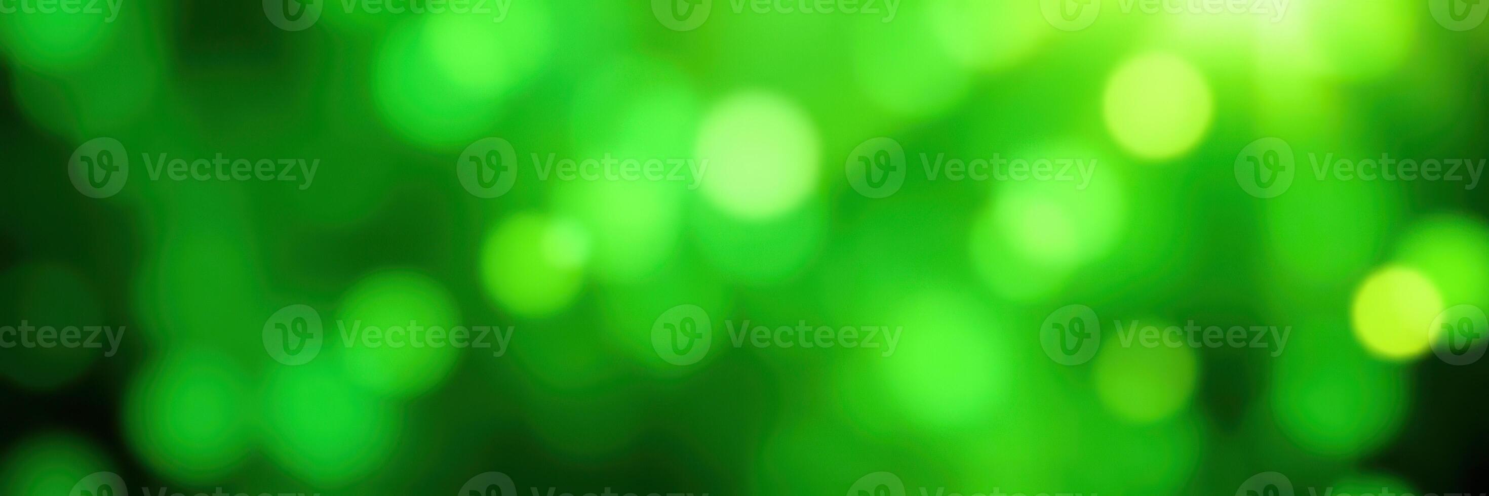 Vibrant green bokeh effect creating a serene atmosphere in a natural setting during the day photo