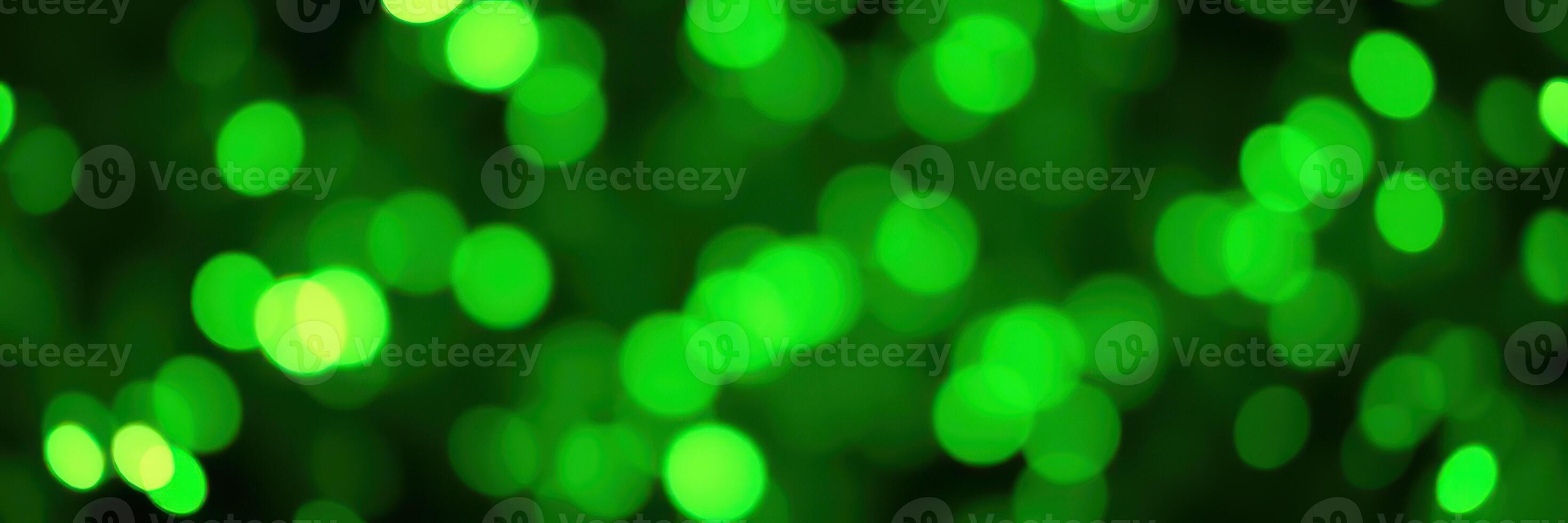 Vibrant green bokeh lights create a festive atmosphere at an evening event in a city park photo