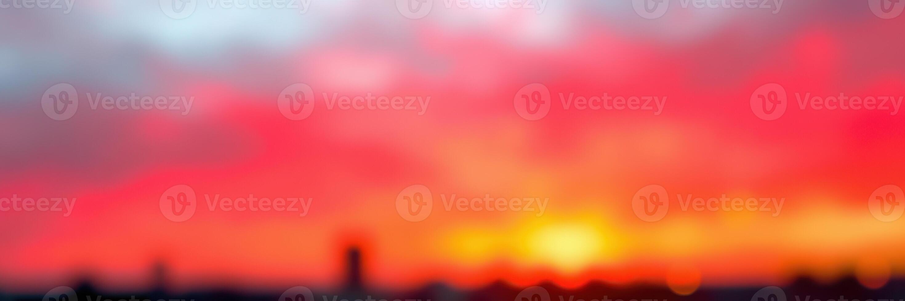 Vibrant sunset with blurred horizon over city skyline creating a dreamy atmosphere during twilight photo