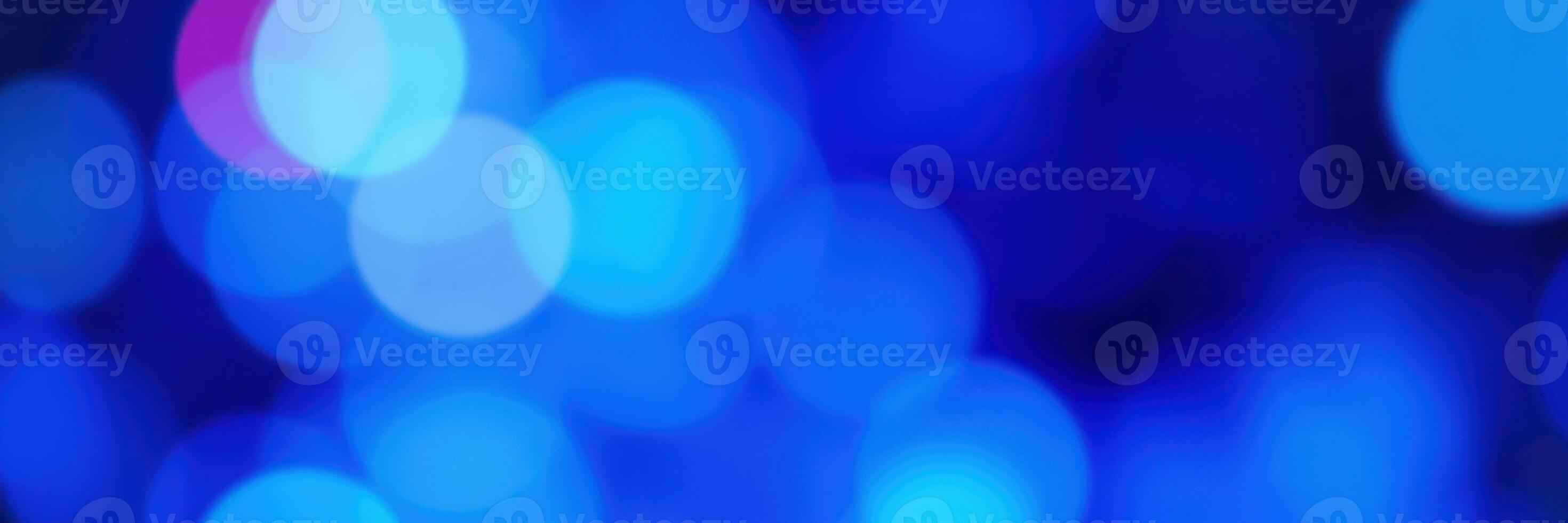 Vibrant blue bokeh lights illuminating a festive atmosphere at a nighttime event photo
