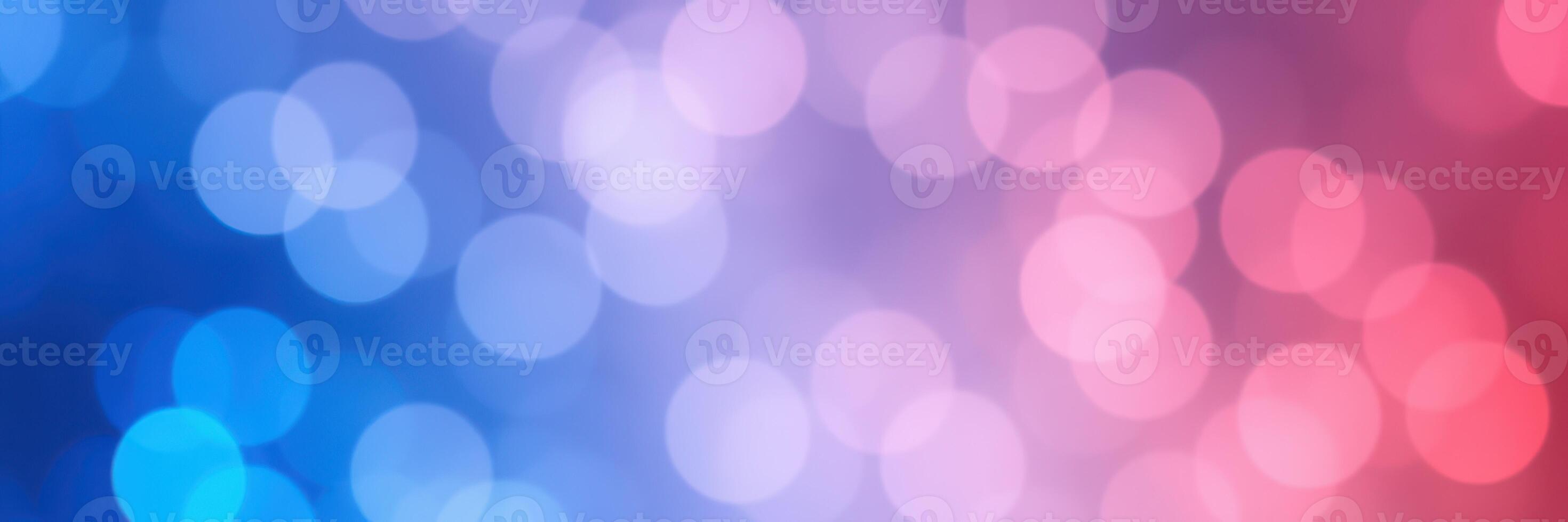 Colorful bokeh background featuring hues of blue, pink, and purple created by soft lighting and blurred circles photo