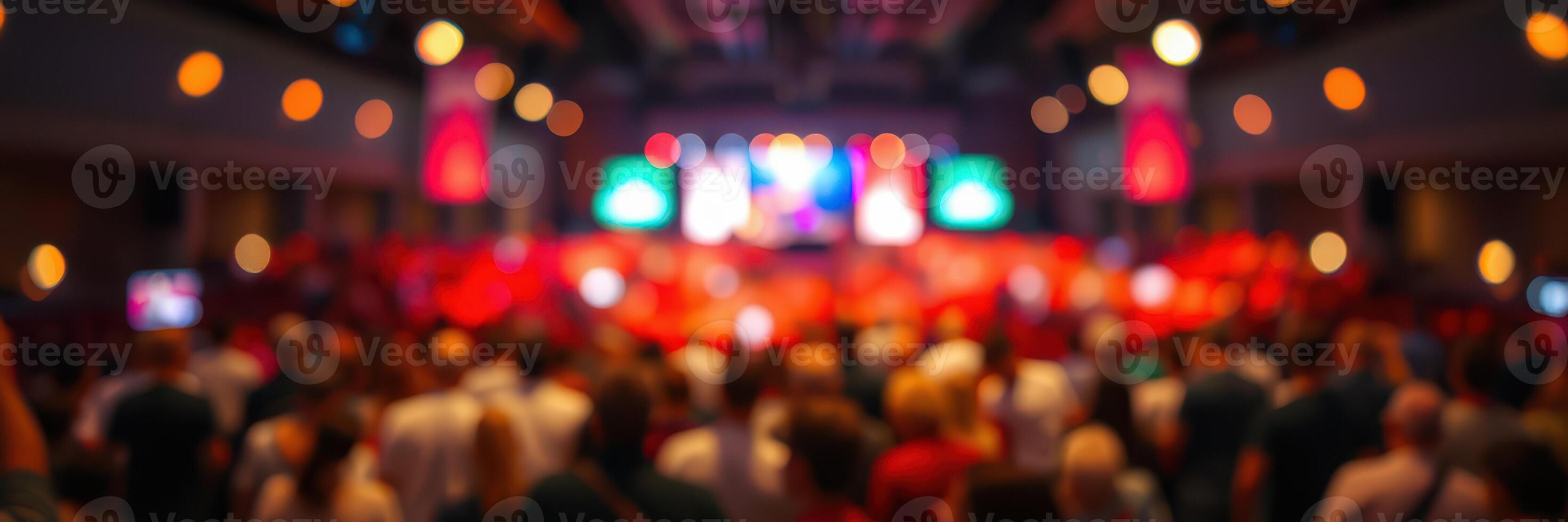 Crowd enjoying a vibrant performance in a lively auditorium at night photo