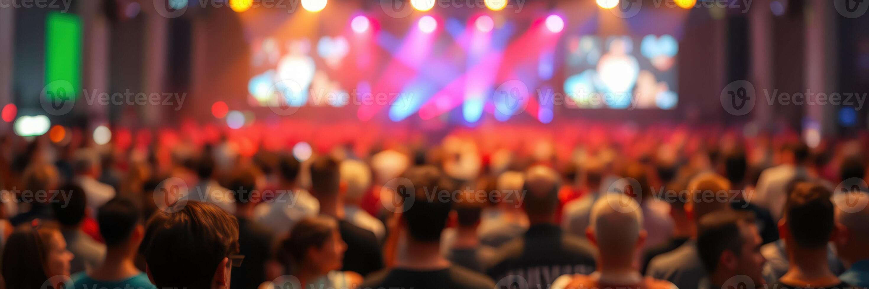 Crowd enjoying an energetic live performance under colorful lights at an entertainment venue photo