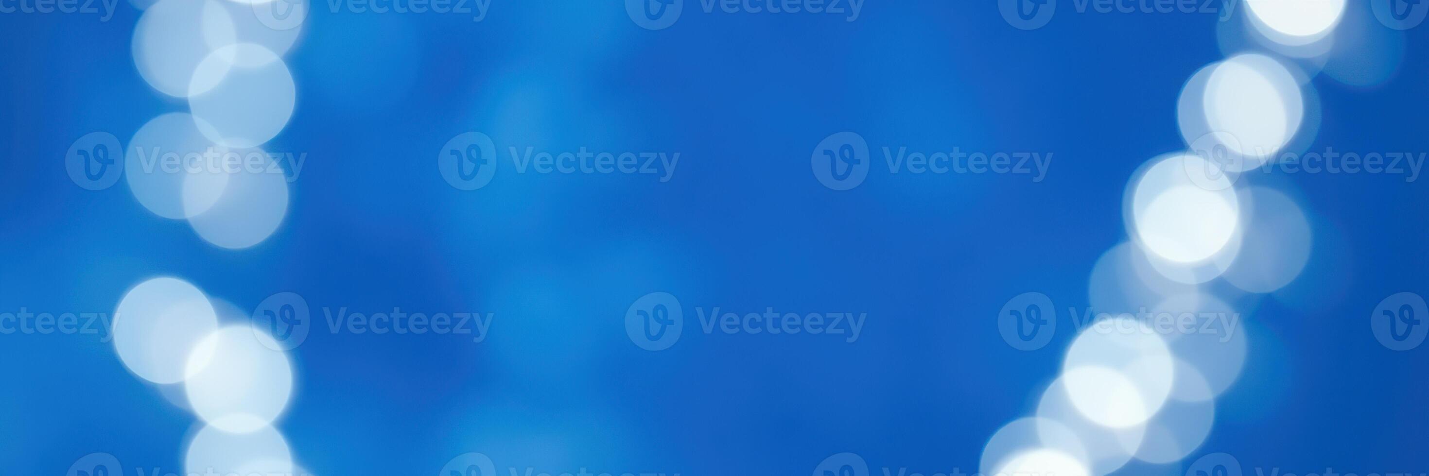 Soft blue background with glowing circular lights creating a dreamy atmosphere at a festive event in the evening photo