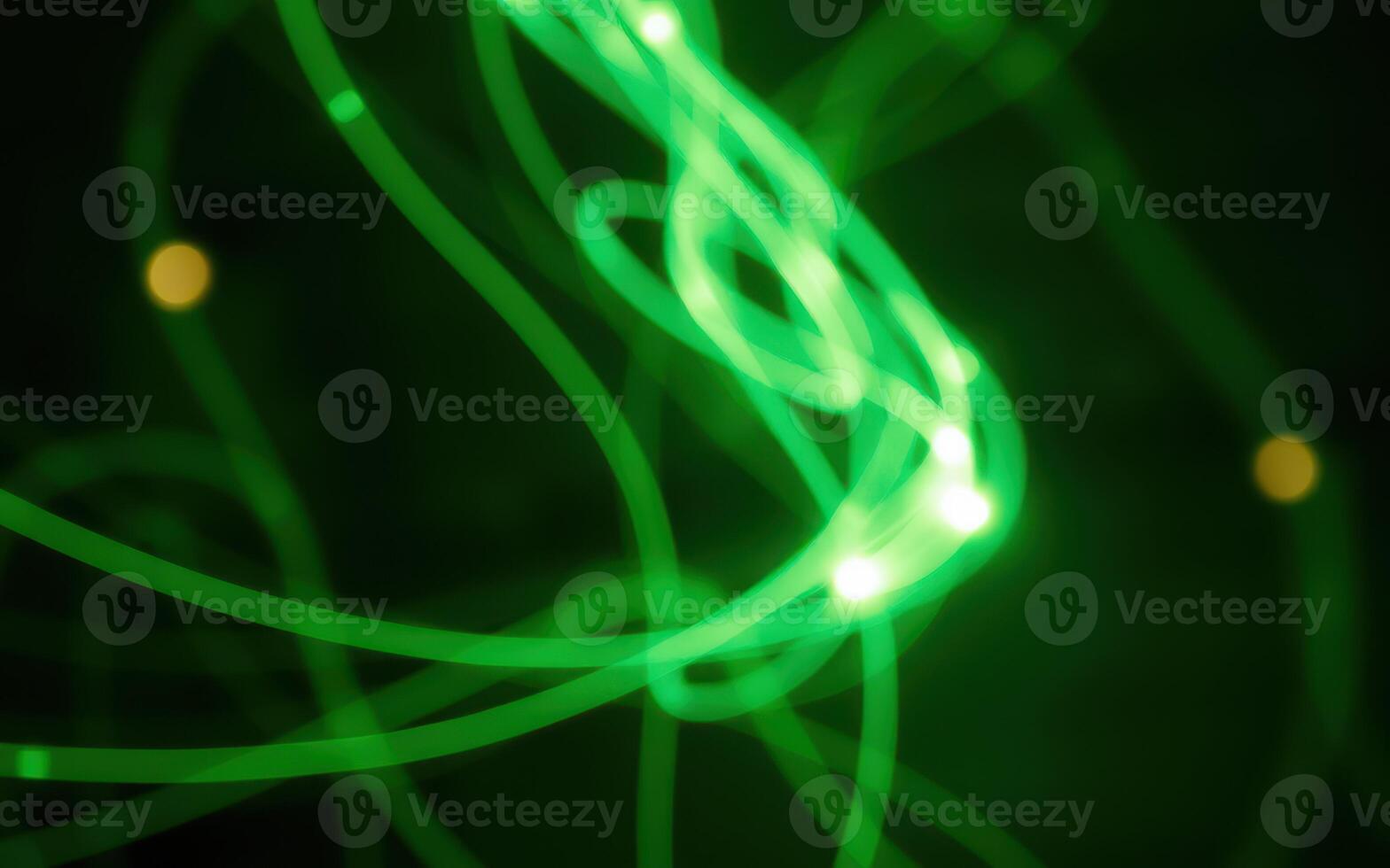 Colorful abstract light trails swirl and dance against a dark background photo