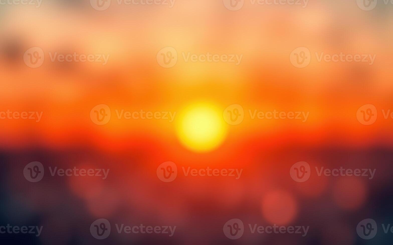 Vibrant sunset casting warm hues over the horizon with blurred clouds creating a serene atmosphere photo