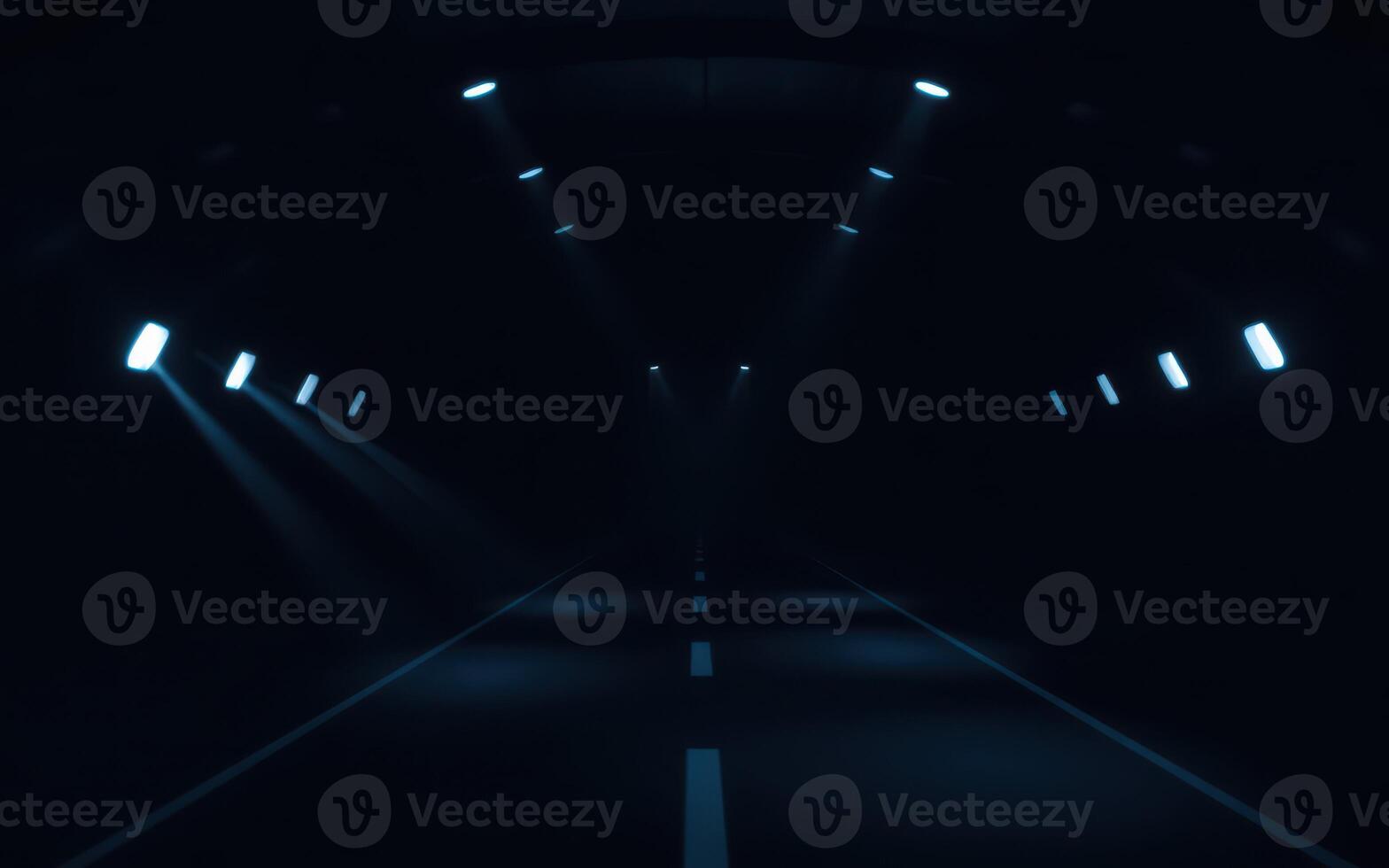 Mysterious dark tunnel illuminated by beams of light with a lonely road ahead photo