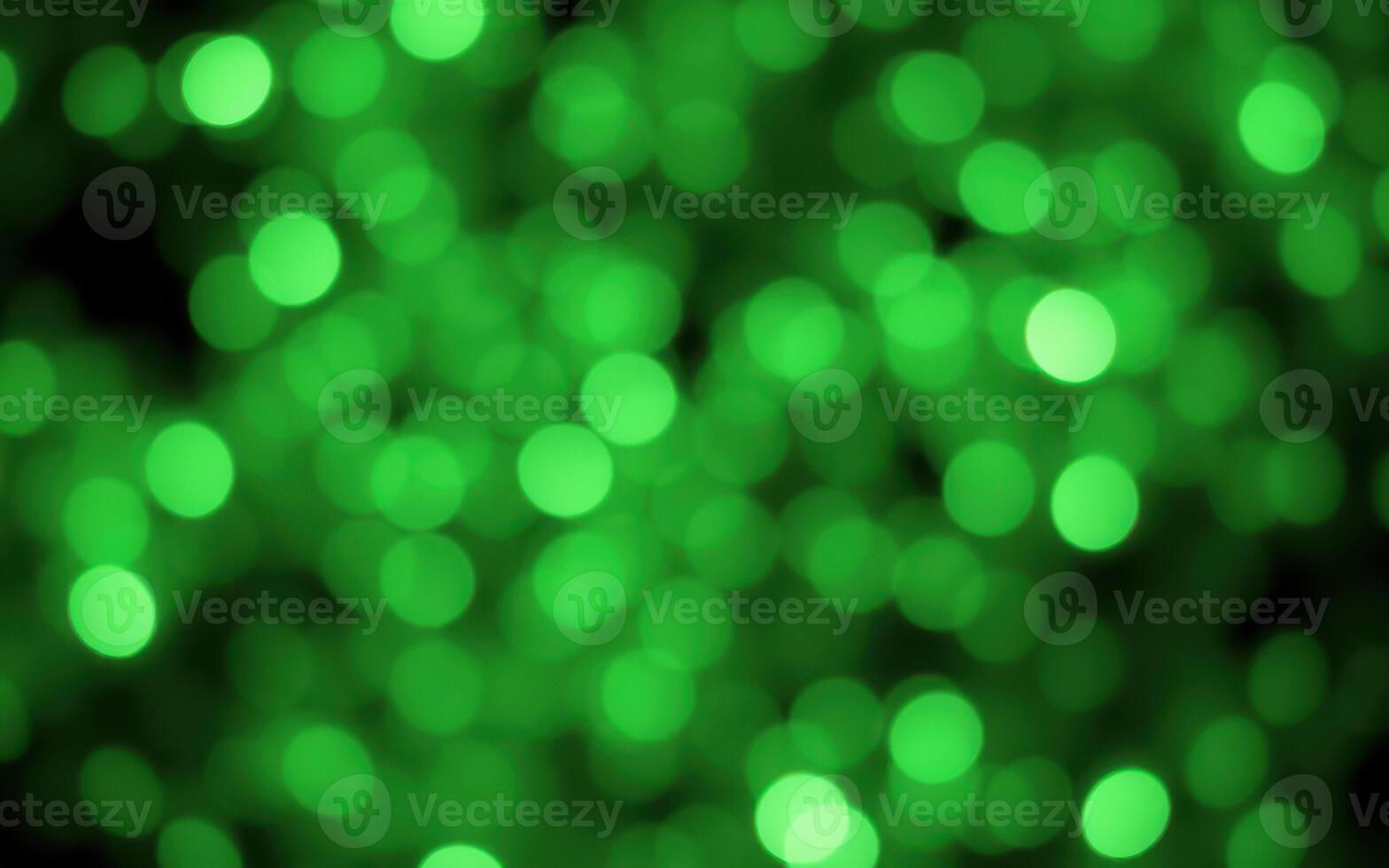 Vibrant green bokeh lights create a festive atmosphere in a nature-inspired setting during a nighttime event photo