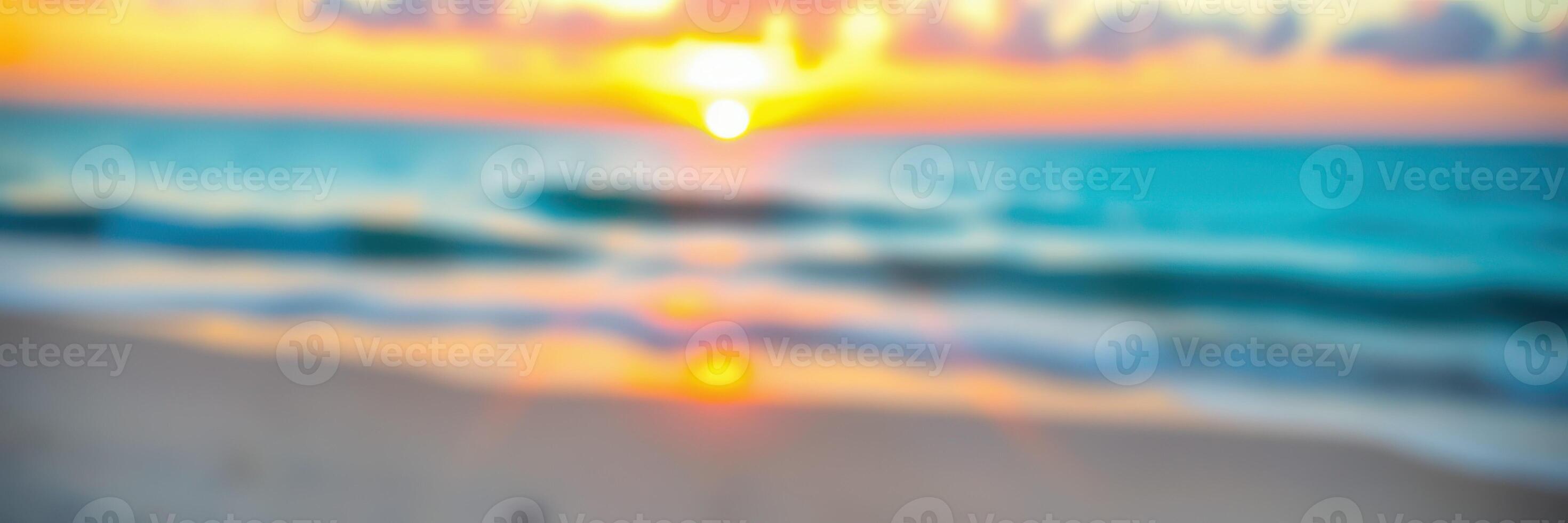 Beautiful sunset over the ocean with soft waves lapping at the sandy shore during twilight photo