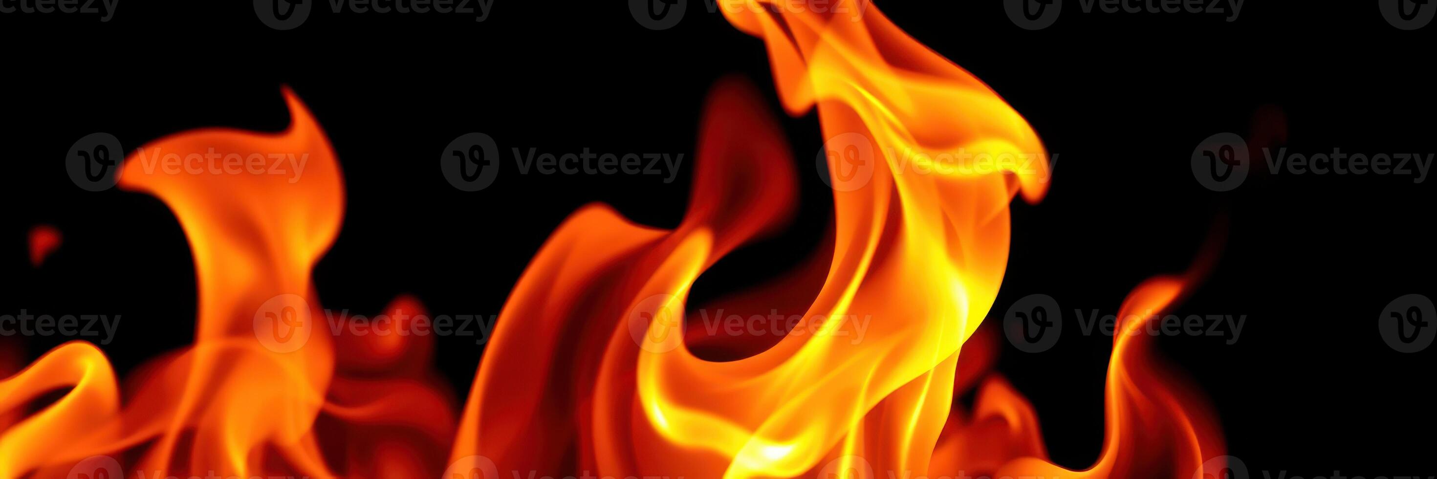 Flames dancing in dark backdrop create mesmerizing display of heat and energy photo